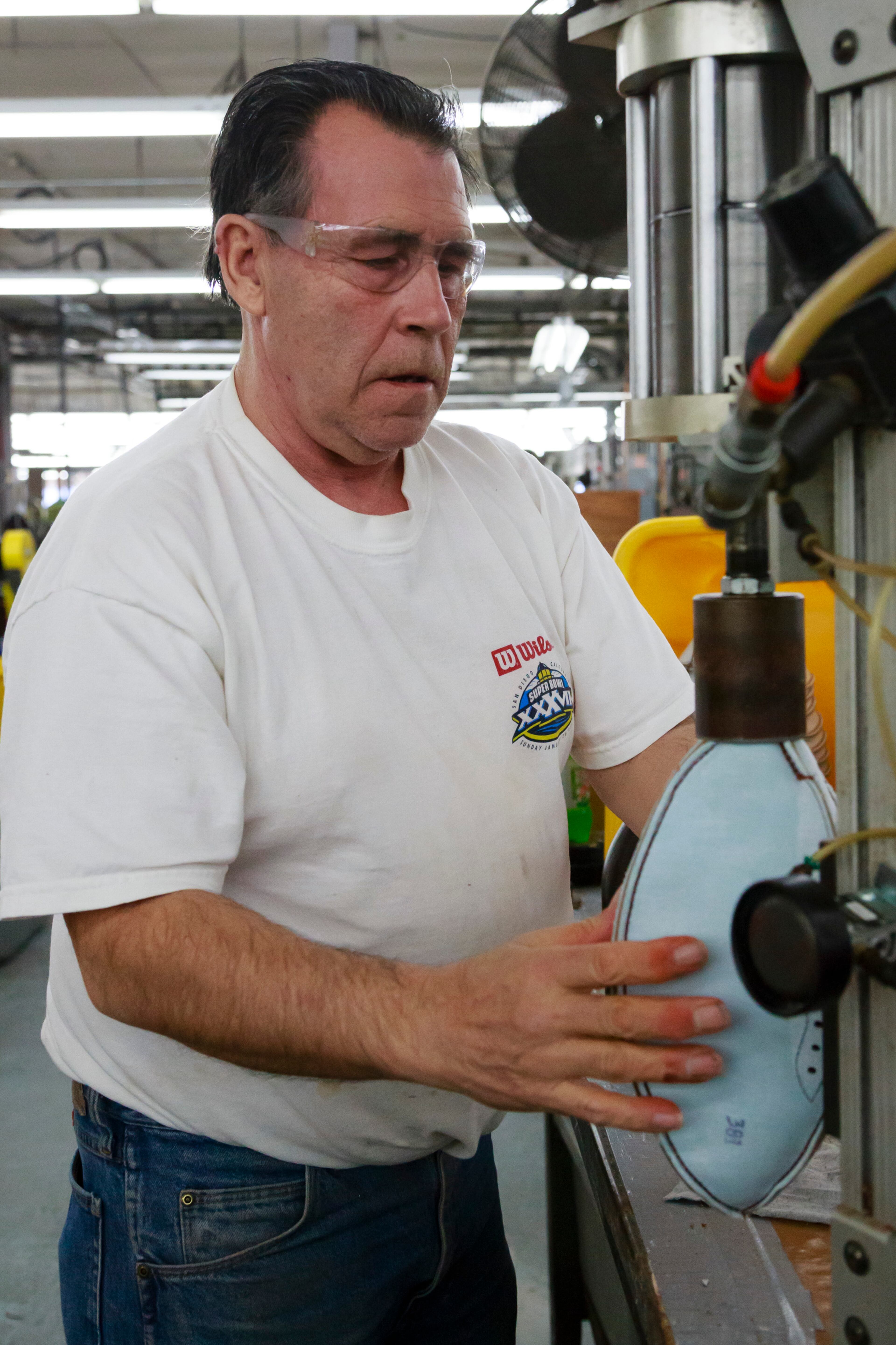 Emmitt Lawrance prepares an official game ball for the NFL football Super Bowl XLVII to be turn inside out at Wilson Sporting Goods Co. in Ada, Ohio, Monday, Jan. 21, 2013. The San Francisco Forty Niners will play the Baltimore Ravens in the Super Bowl on Feb. 3 in New Orleans. (AP Photo/Rick Osentoski)