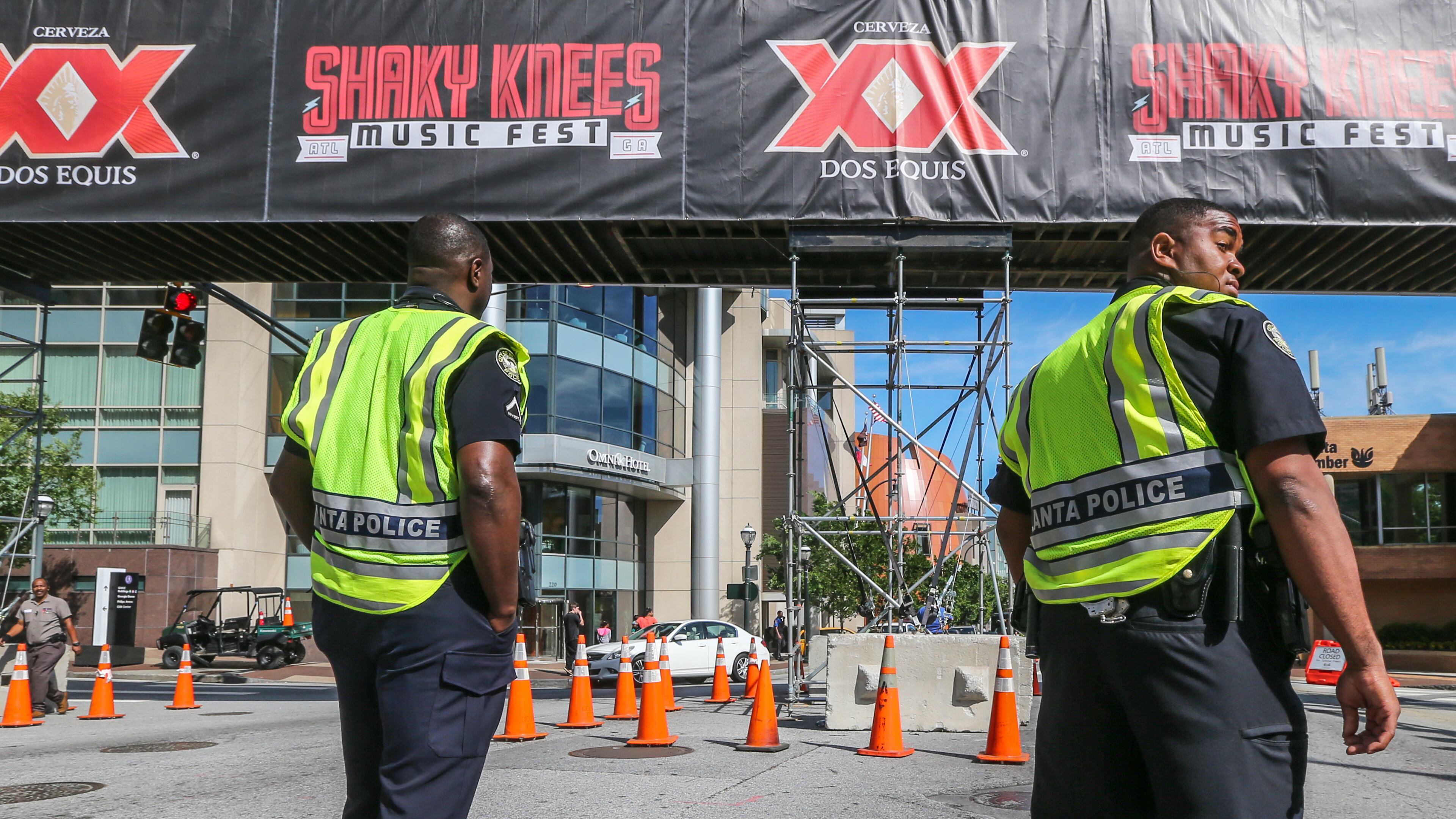 Atlanta police officers stand their post on Marietta Street outside CNN Center where a large overpass was installed as final preparations were made Friday morning, May 13, 2016, for about 75 musical acts that will take the stage at the Shaky Knees Music Festival. JOHN SPINK / JSPINK@AJC.COM