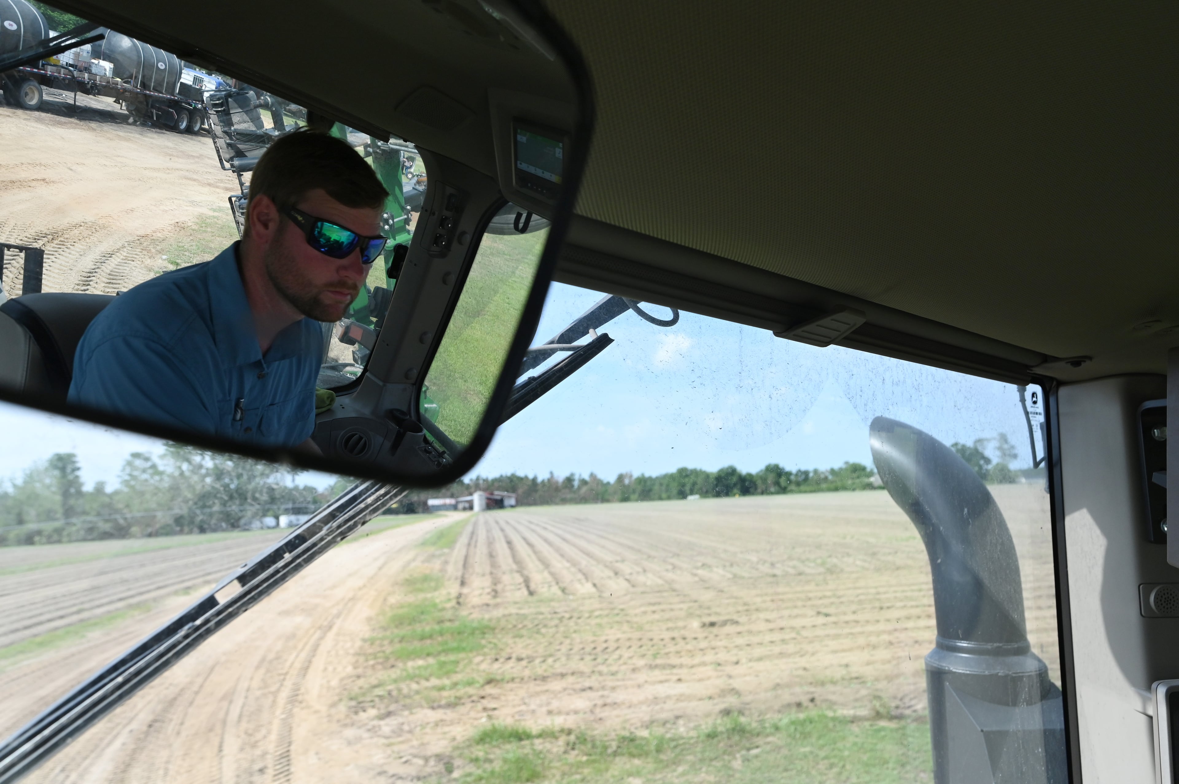 Daniel Raulerson, owner of DLR Farms in Coffee County, operates his tractor Wednesday in Douglas. Raulerson estimates he lost about half his 2024 cotton yield when Helene’s winds barreled through his cotton crop in September. (Hyosub Shin/AJC)