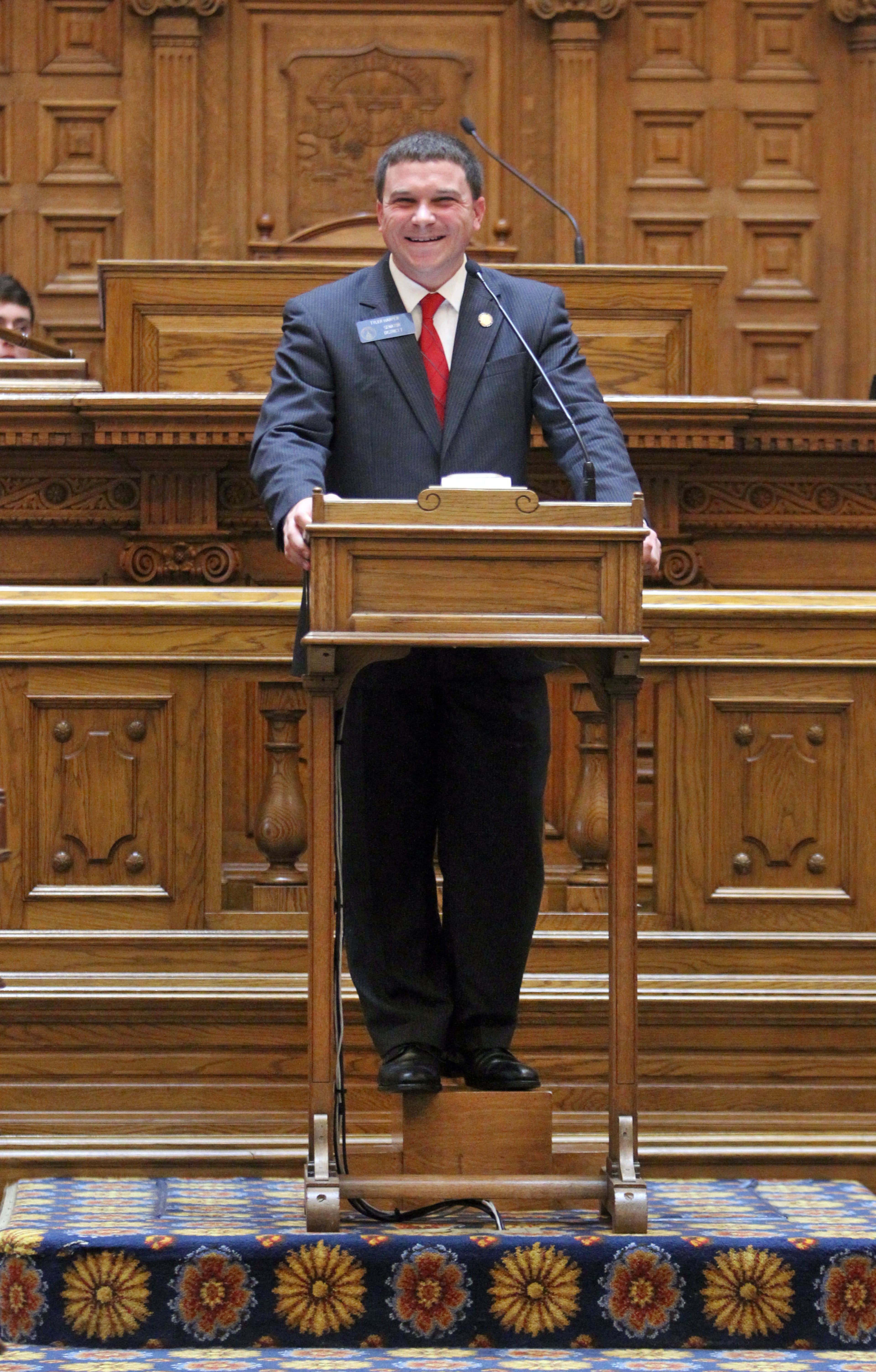 Freshman Sen. Tyler Harper, R-Ocilla, stands on a stool at the podium as he gets "hazed" as he introduces his first bill, Senate Bill 91, Wednesday, Feb. 13, 2013. Every time a freshman senator sponsors a first bill fellow senators "haze" them in the Senate chambers as a sort of rite of passage.