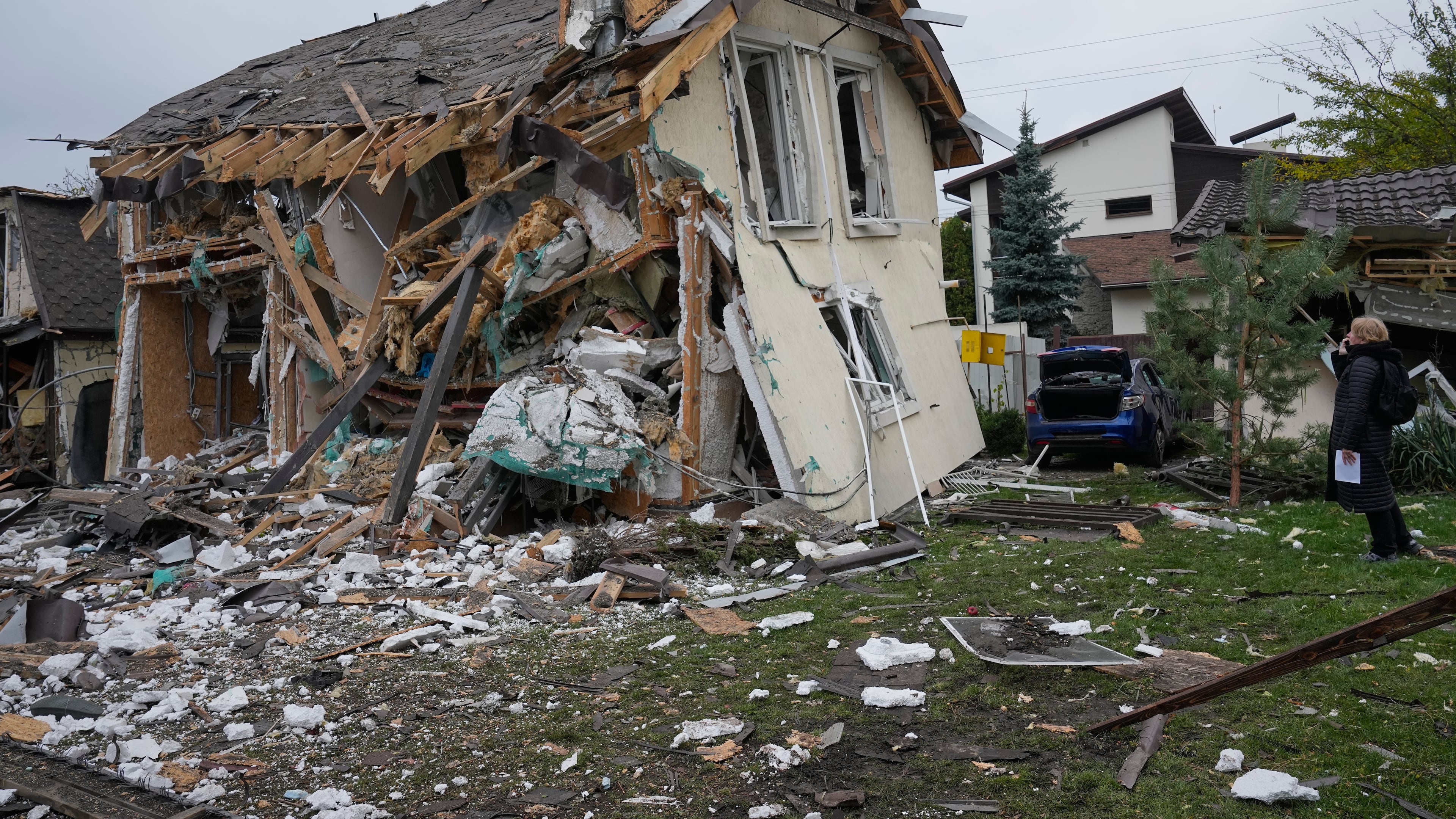 A woman looks at residential house destroyed in a Russian missile strike in Kyiv, Thursday, Oct. 22, 2026. (AP Photo/Efrem Lukatsky)