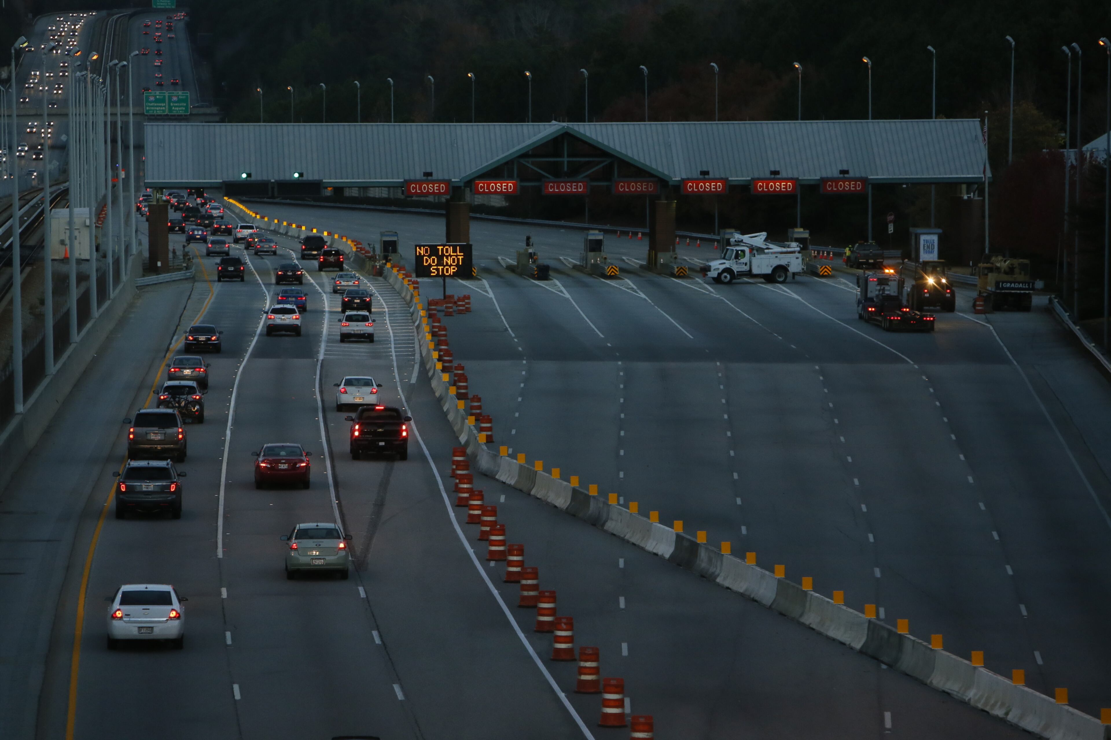 Rerouted traffic on the now toll-free GA 400 was flowing smoothly Monday morning as commuters swung around the barricaded toll plaza and were funneled through three of the old Cruise Card lanes with apparent ease, AJC staff writer Andria Simmons reports. BOB ANDRES/BANDRES@AJC.COM