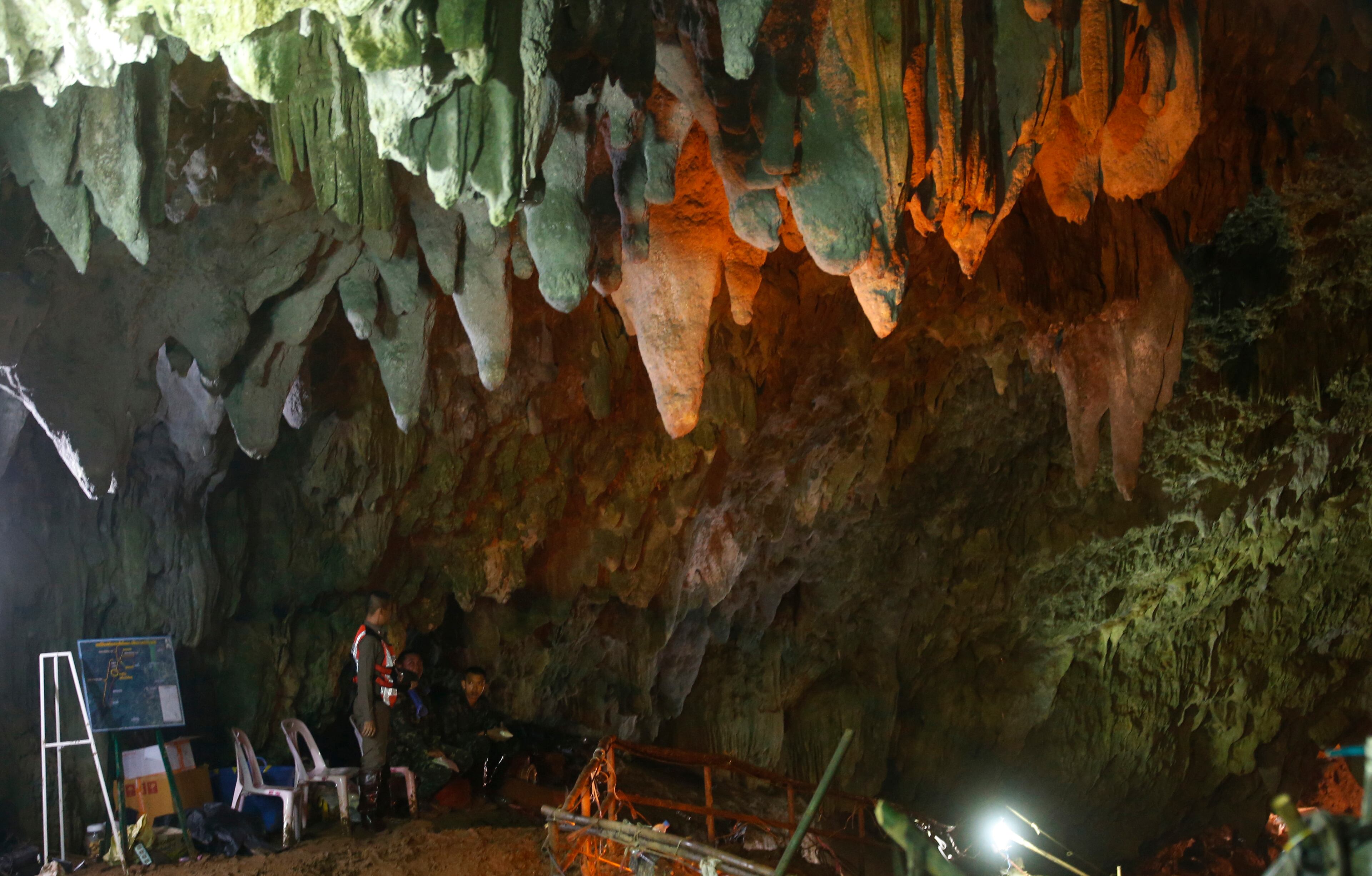 Thai police guard the entrance to a cave complex where 12 boys and their soccer coach went missing, in Mae Sai, Chiang Rai province, in northern Thailand, Sunday, July 1, 2018. The frantic effort to locate them in the cave for a week picked up pace as a break in the rain eased flooding in the system of caverns and more experts from around the world joined the anxious rescue mission. (AP Photo/Sakchai Lalit)