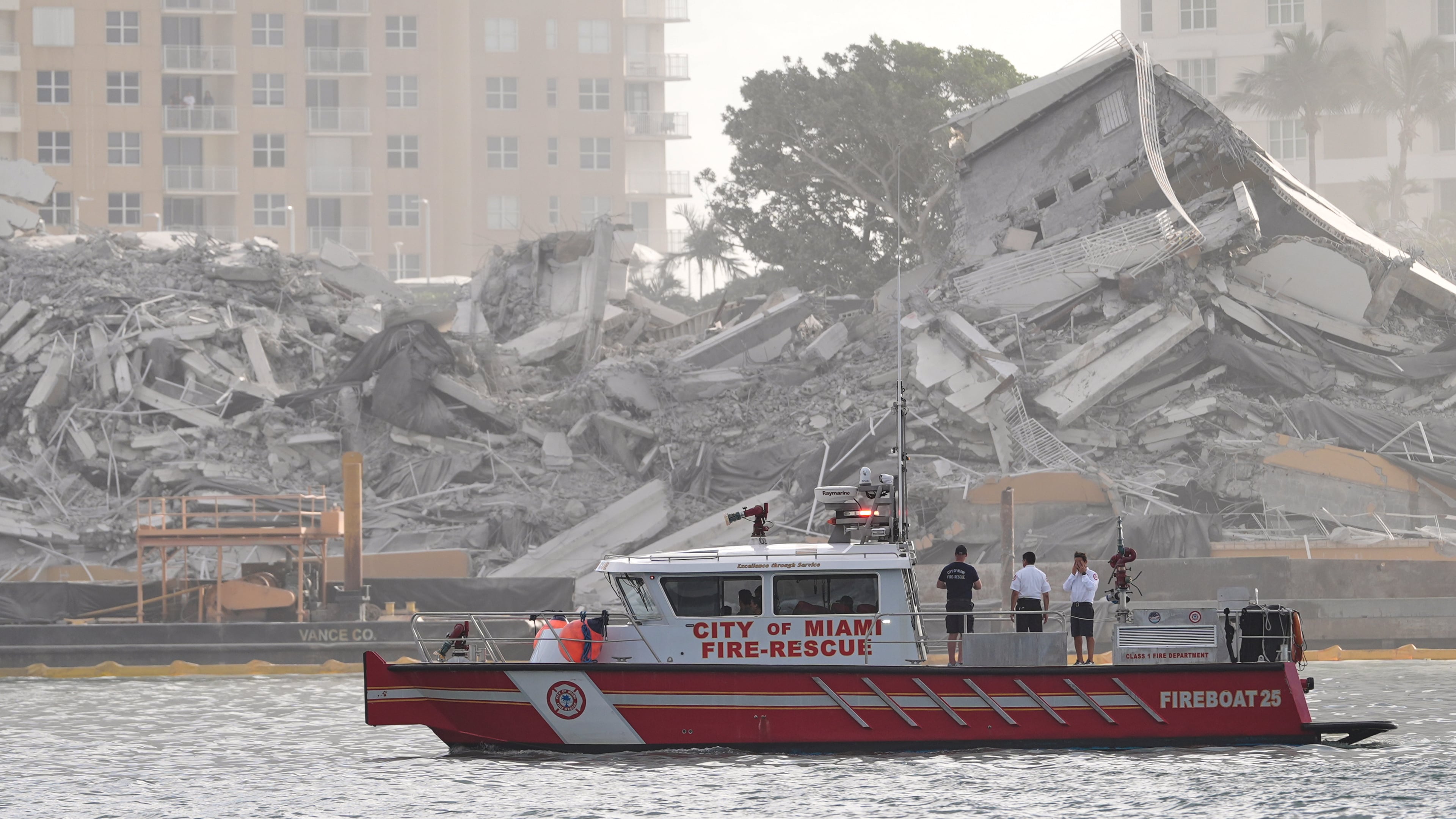 A Miami Fire-Rescue boat surveys debris following the controlled implosion of the former Mandarin Oriental Hotel on Brickell Key, Sunday, April 12, 2026, in Miami. (AP Photo/Rebecca Blackwell)