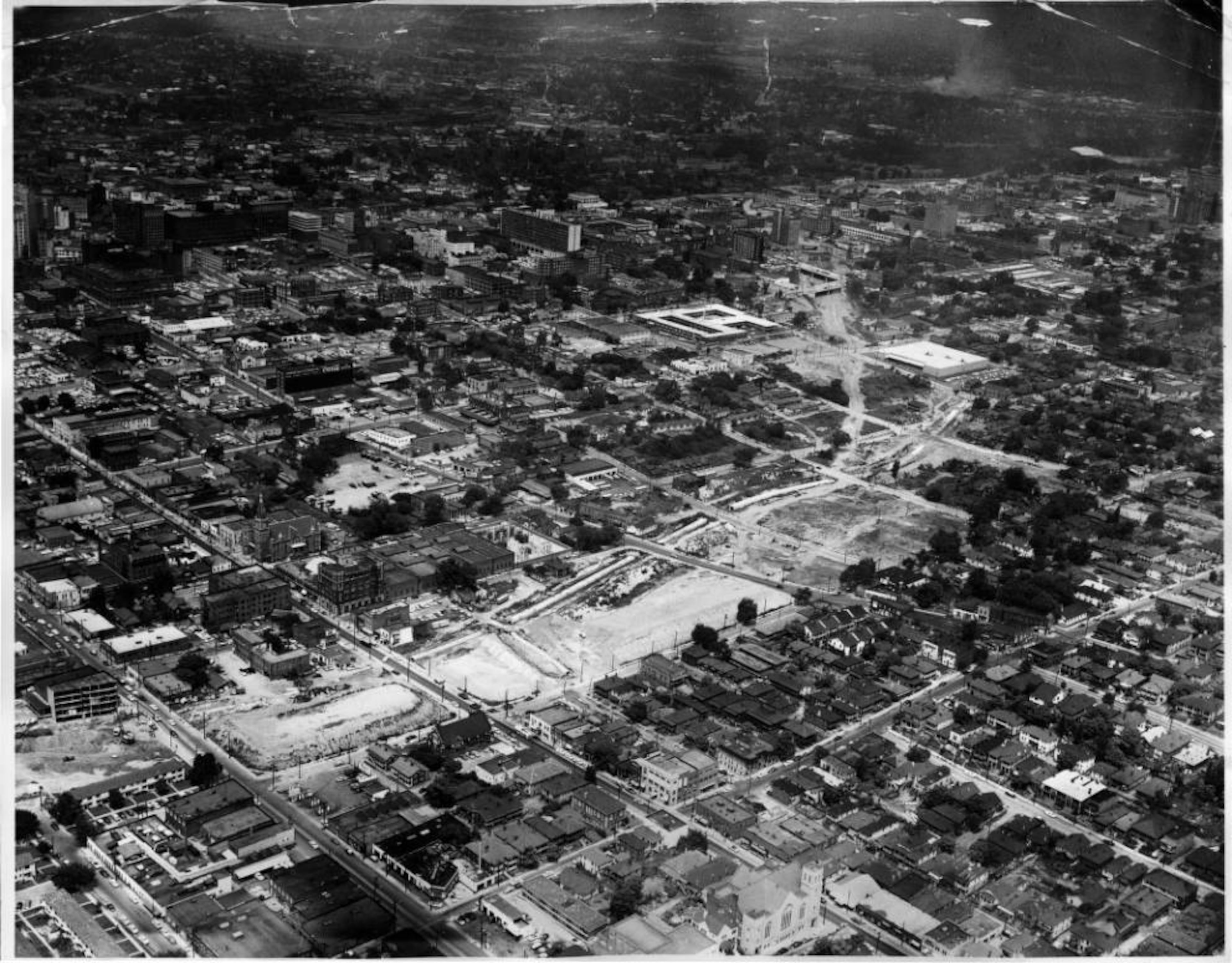 Aerial photograph of showing demolition for the Downtown Connector. Edgewood and Auburn Avenues are seen in the foreground. Early 1950s. AJC file
