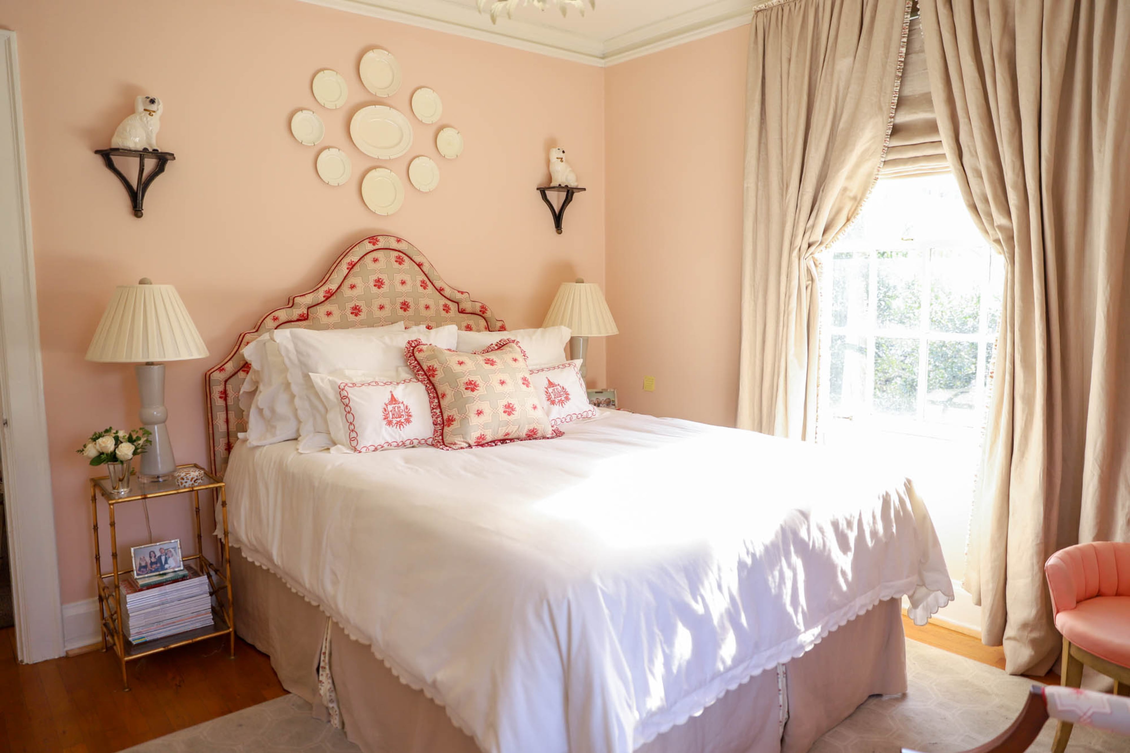 The creamware collection over the bed Anna-Louise Wolfe found on eBay, and the Staffordshire dogs resting on brackets came from an antique store in Rome, Ga. The wall is painted Love Always from Benjamin Moore.