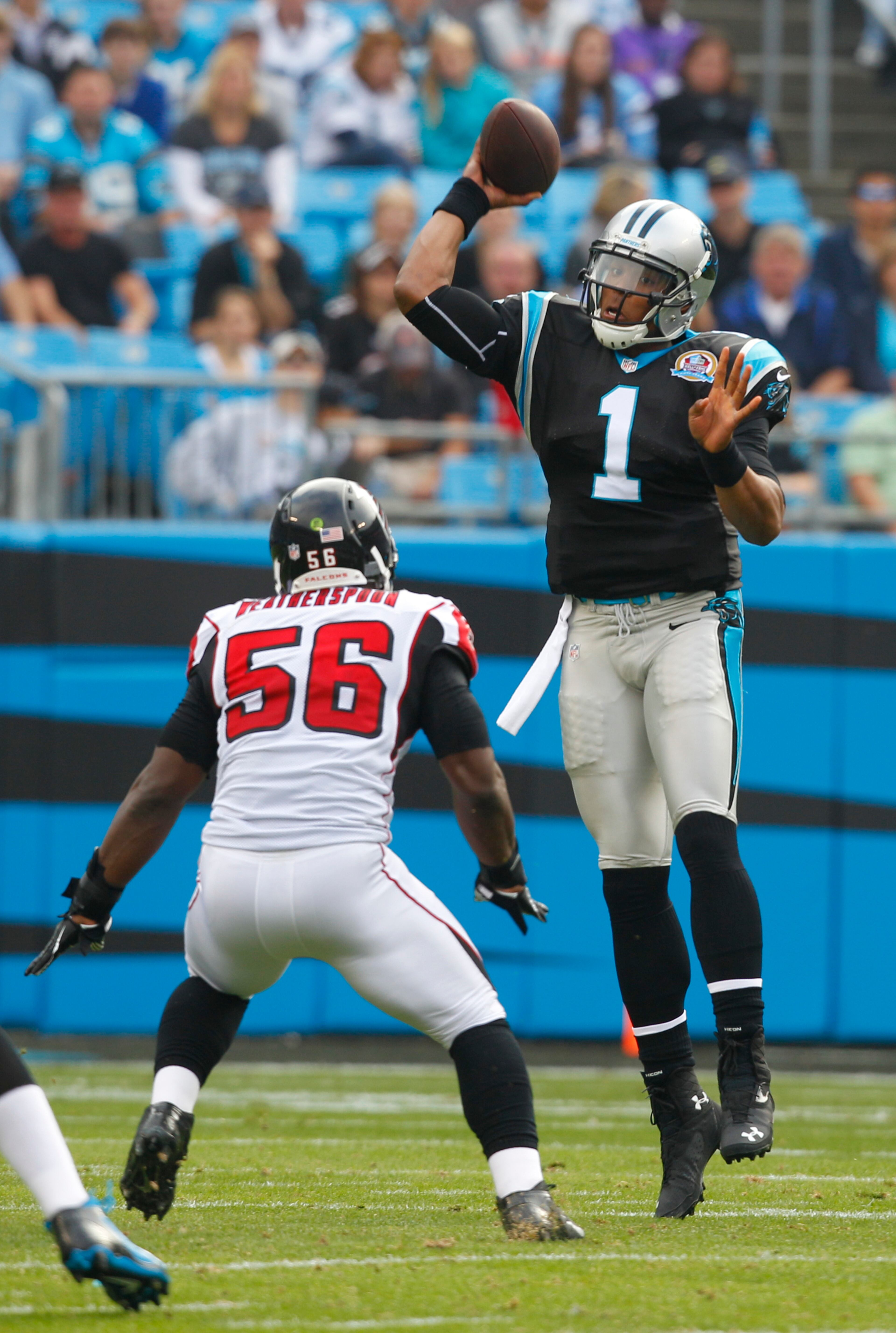 Carolina Panthers' Cam Newton (1) throws a pass as Atlanta Falcons' Sean Weatherspoon (56) defends during the first half of an NFL football game in Charlotte, N.C., Sunday, Dec. 9, 2012. (AP Photo/Chuck Burton)