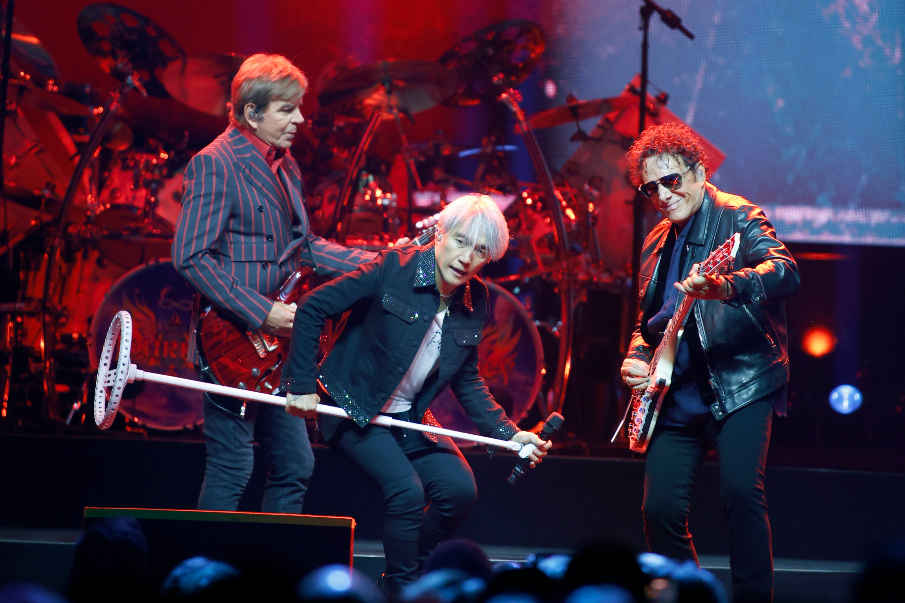 Journey guitarist Jonathan Cain, lead vocalist Arnel Pineda and founding member and lead guitarist Neal Schon performing at State Farm Arena, Monday, Oct. 19, 2026. (Akili-Casundria Ramsess for the AJC)