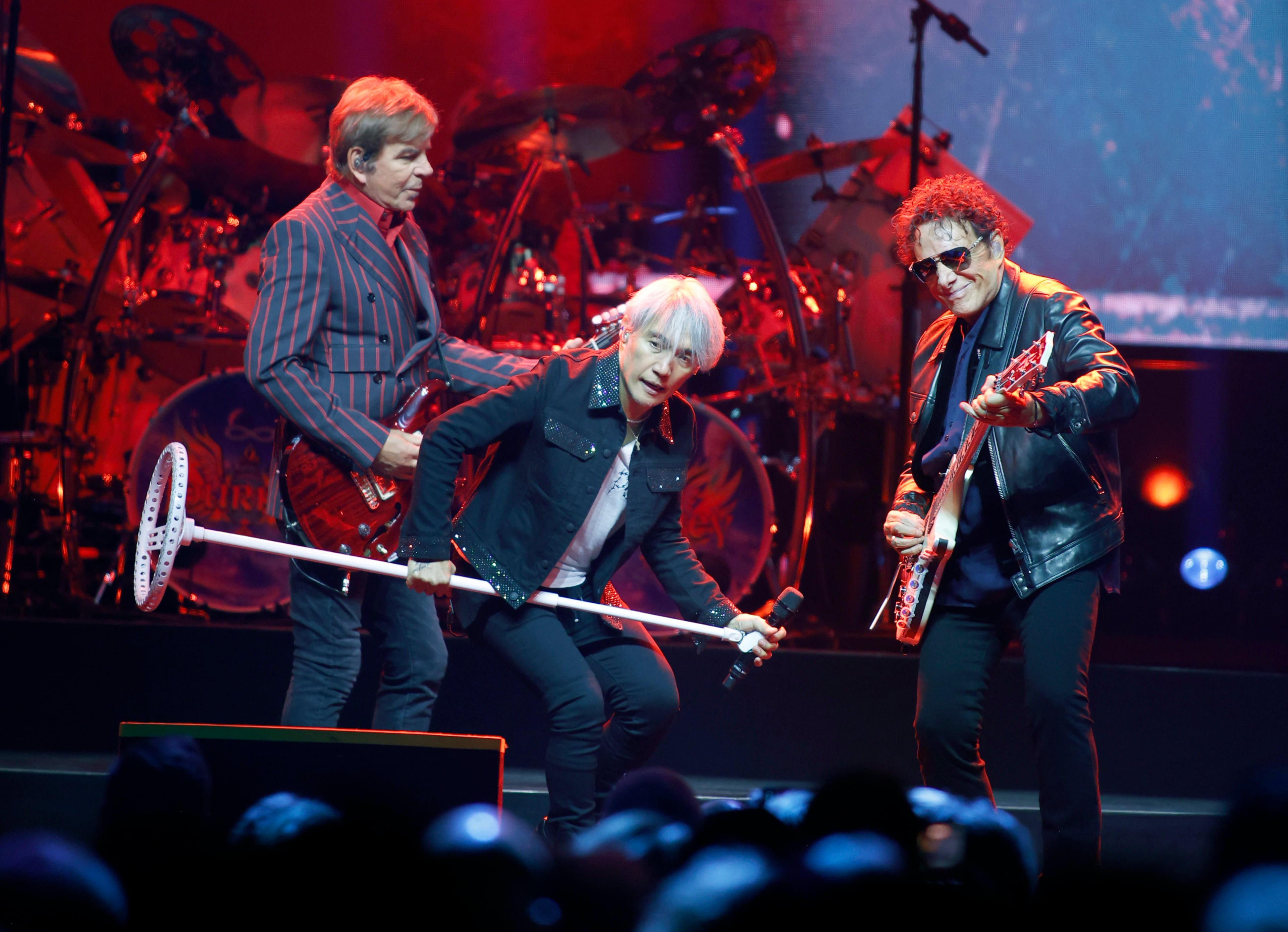 Journey guitarist Jonathan Cain, lead vocalist Arnel Pineda and founding member and lead guitarist Neal Schon performing at State Farm Arena, Monday, Oct. 19, 2026. (Akili-Casundria Ramsess for the AJC)