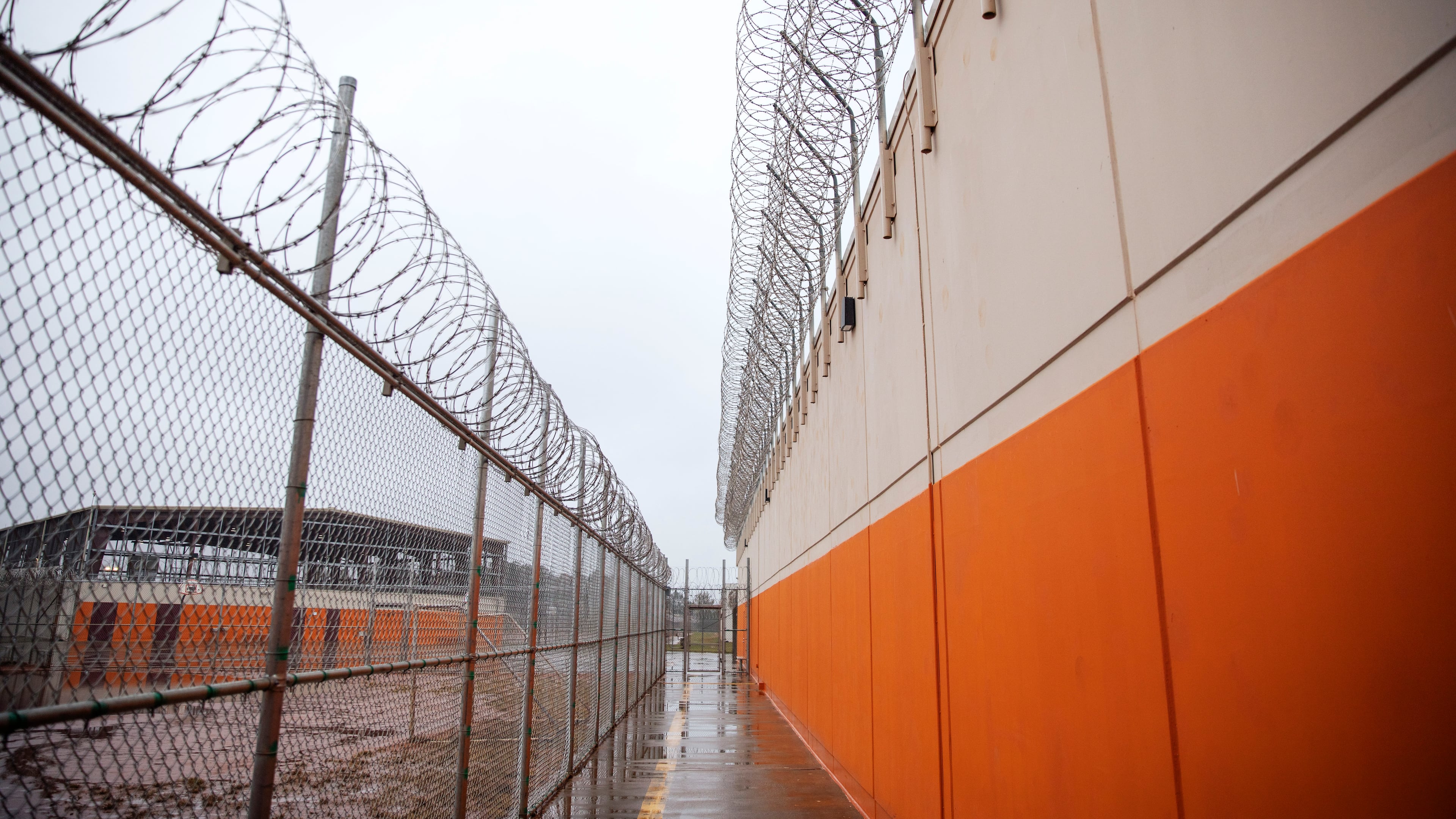 Barbed wire lines a recreation area at the Stewart Detention Center in Lumpkin, Ga. Judges have been denying bond to detained immigrants at high rates since Donald Trump reclaimed the White House. (David Goldman/AP 2019)