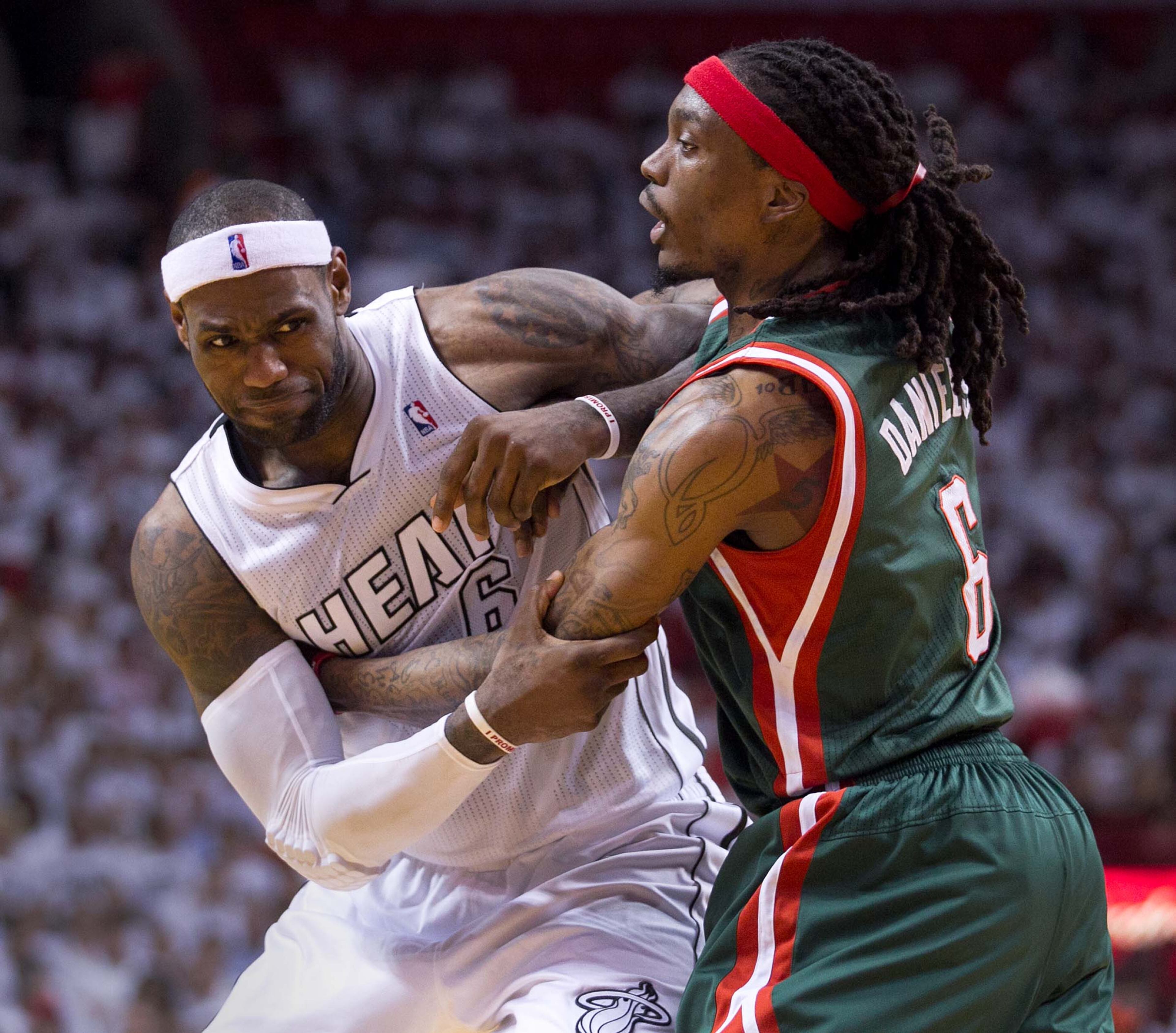 Miami Heat small forward LeBron James (6) struggles to get away from Milwaukee Bucks small forward Marquis Daniels (6) at AmericanAirlines Arena on April 21, 2013. Daniels was called for a foul on the play in the second quarter. (Allen Eyestone/The Palm Beach Post)