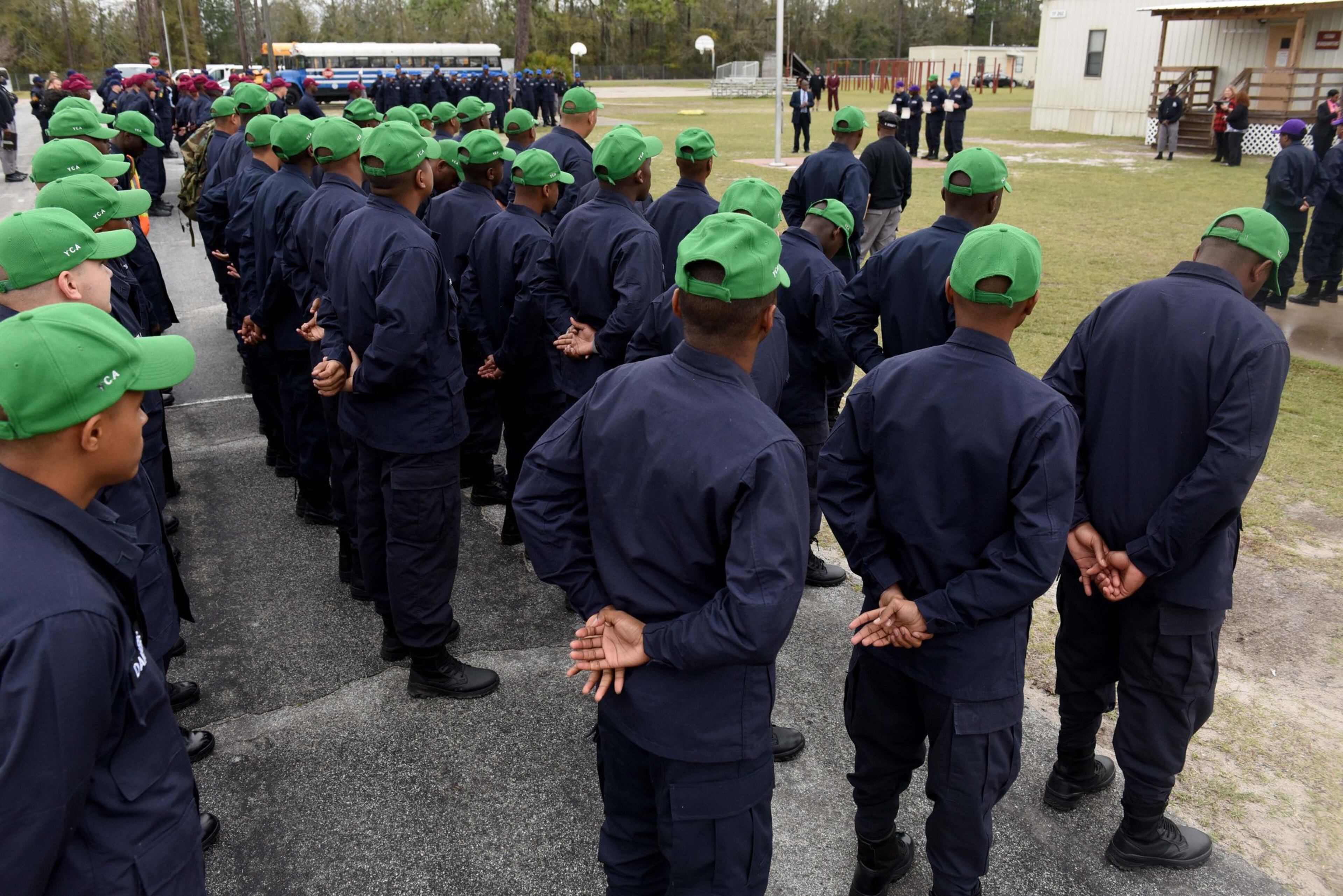 Cadets at the Fort Stewart Youth Challenge Academy stand in formation during a campus tour in February 2020. An AJC investigation in 2020 found the state-run boot camp’s adult platoon instructors — known as cadre — physically abused teenage cadets and sexually harassed female staff. The YCA program offers a quasi-military experience for teens, age 16 to 18, dividing them into platoons. The program's Fort Gordon camp made news in October 2022 when a massive brawl between different platoons caused leaders to shut down the class and send the cadets home. RYON HORNE / RHORNE@AJC.COM