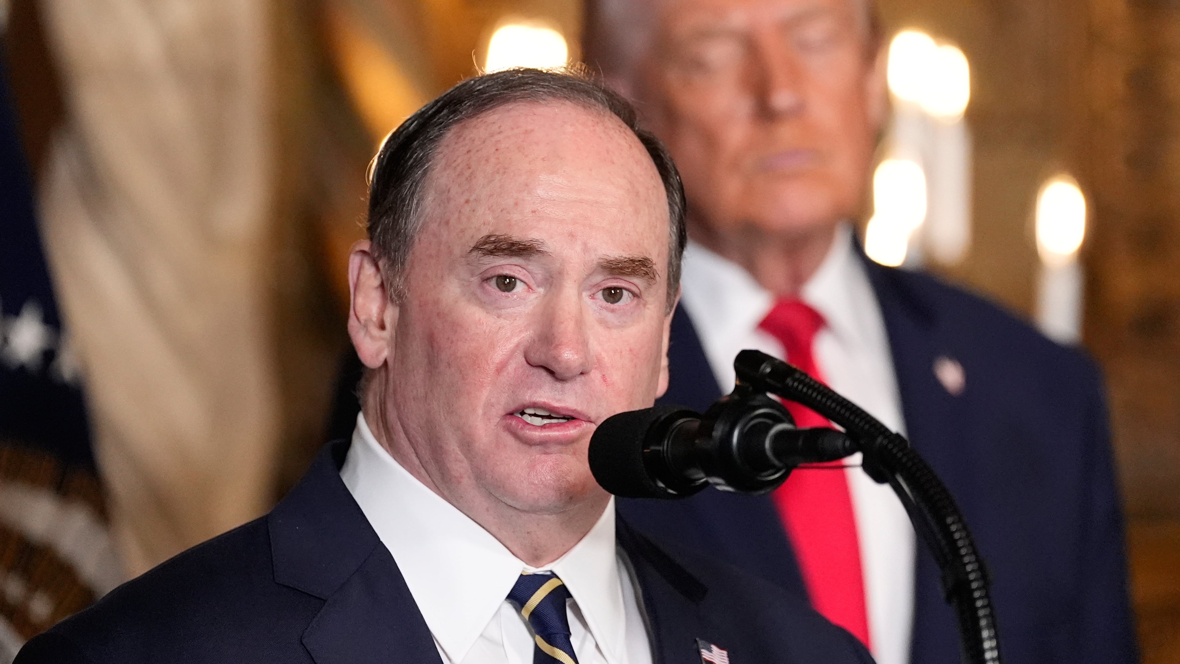 FILE - Secretary of the Navy John Phelan speaks, as President Donald Trump listens, at Trump's Mar-a-Lago club, Dec. 22, 2025, in Palm Beach, Fla. (AP Photo/Alex Brandon, file)