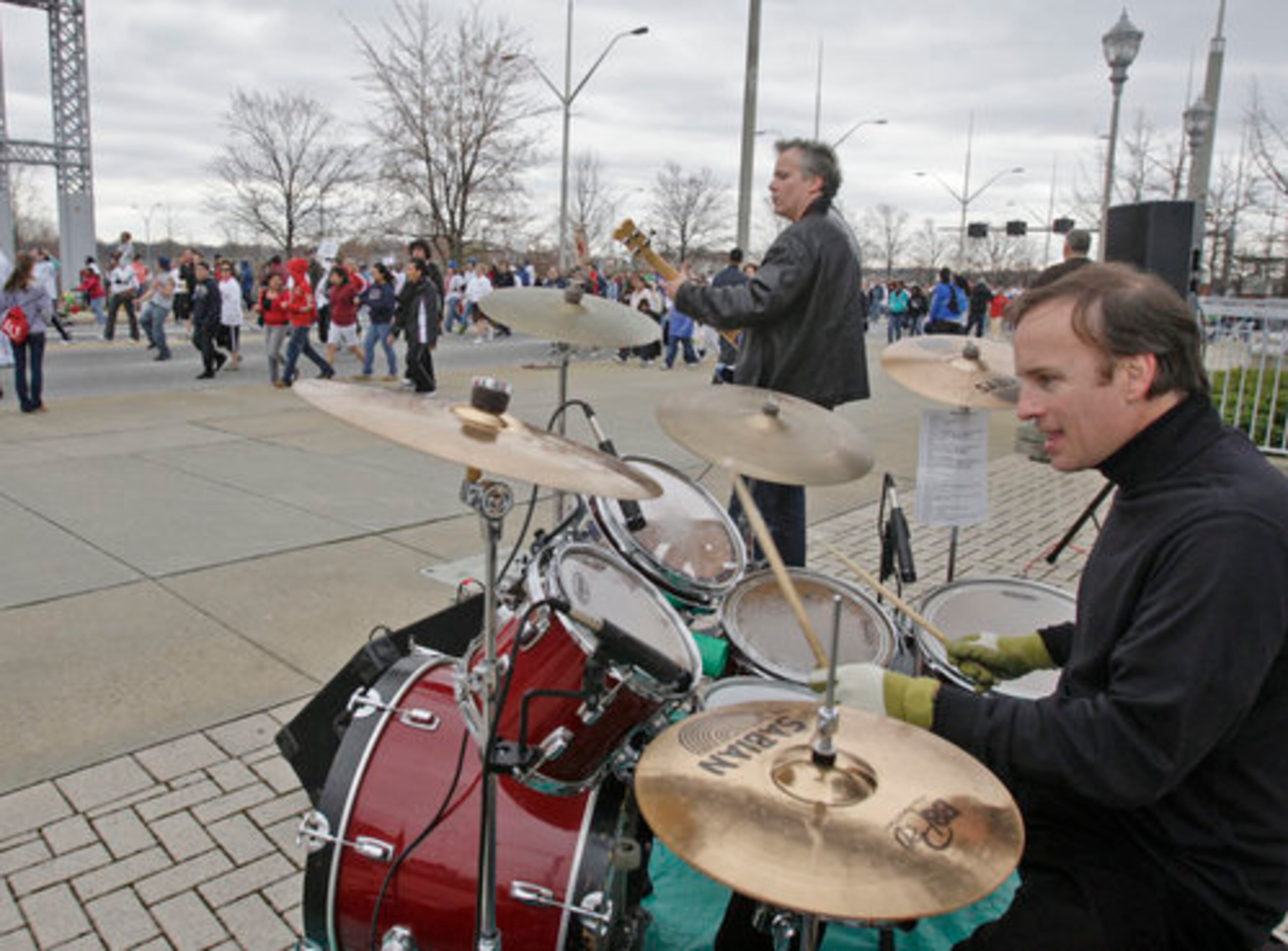 The "Stratogeezers", including drummer Mike Perez and guitar and bass player Thom Brewer entertain the walkers as they head down Capitol Ave. The Seed and Feed Marching Abominable Band kicked off runners and walkers, and other entertainment groups kept the beat going along the route. The 26th annual hunger walk in downtown Atlanta. More than 10,000 participants were expected to gather at Turner Field to run and walk the 5K route through Downtown.