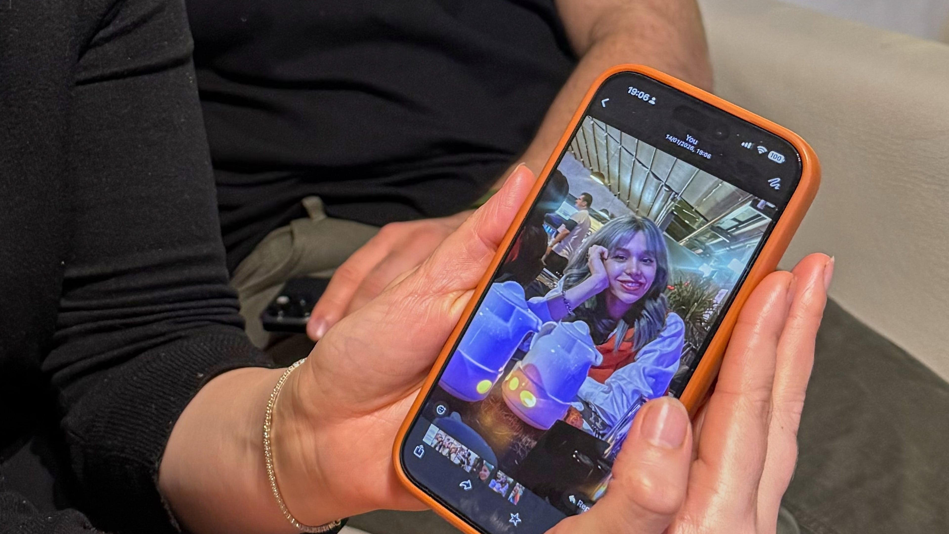 Hali Norei shows a picture of her 23-year-old niece Robina Aminian as she gives an interview alongside her partner Nezar Minoei, in Oslo, Norway, Wednesday, Jan. 14, 2025. Aminian, a university student, was killed during Iran's protests. (AP Photo/Bjornar Verpeide)