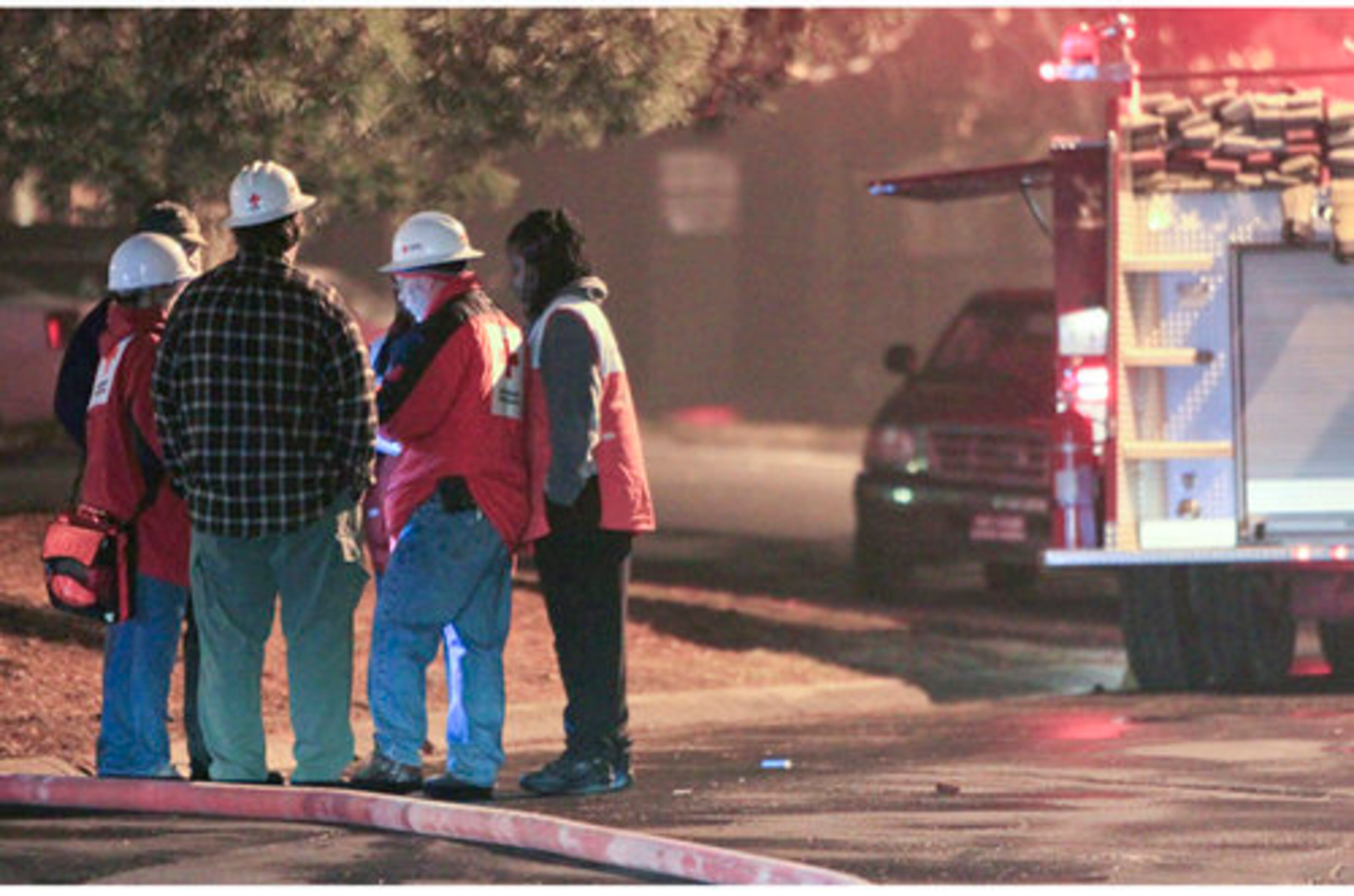 American Red Cross workers gather to assist residents Tuesday. Firefighters discovered two bodies after dousing an apartment blaze in Riverdale Tuesday, Feb. 1, 2011.
