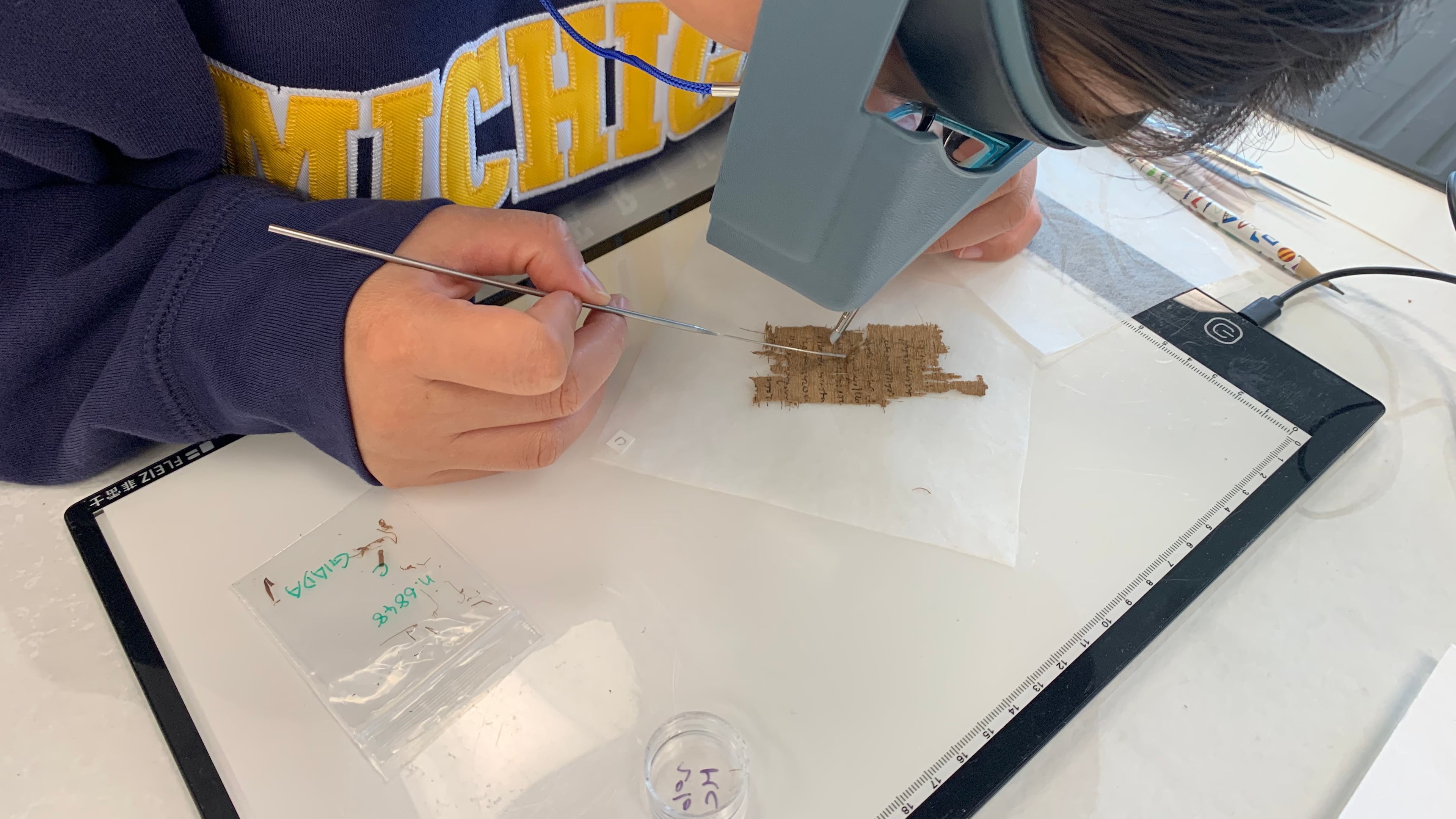 Papyrus Conservation Summer Seminar student Shijin (Giada) Jiang examines a papyrus fragment at the University of Michigan, Thursday, Aug. 6, 2026, in Ann Arbor, Mich. (AP Photo/Mike Householder)