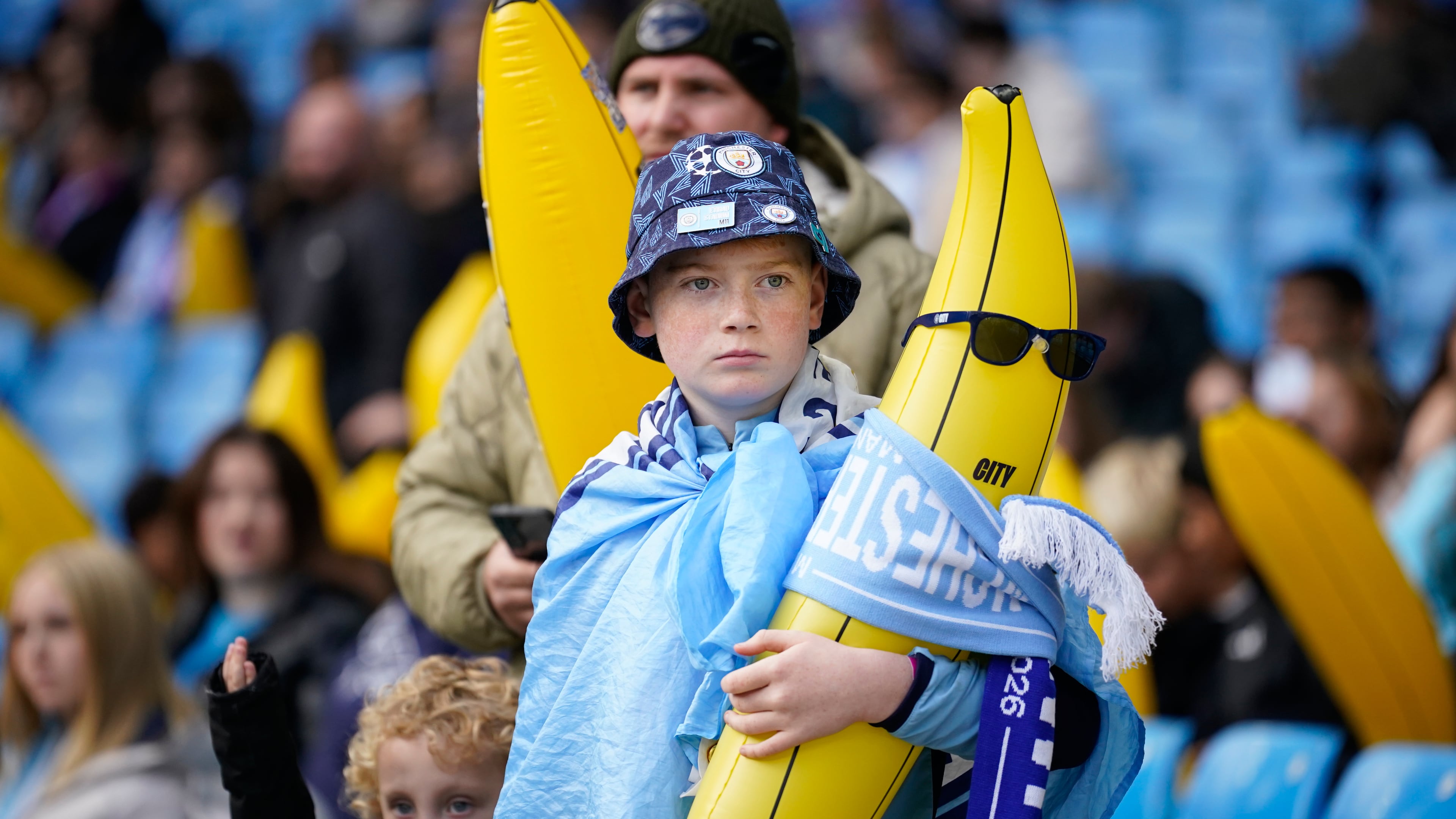 A Manchester City supporter holds an inflatable banana prior to the start of the English Premier League soccer match between Manchester City and Ipswich Town, in Manchester, England, Saturday, Oct.17, 2026. (AP Photo/Dave Thompson)