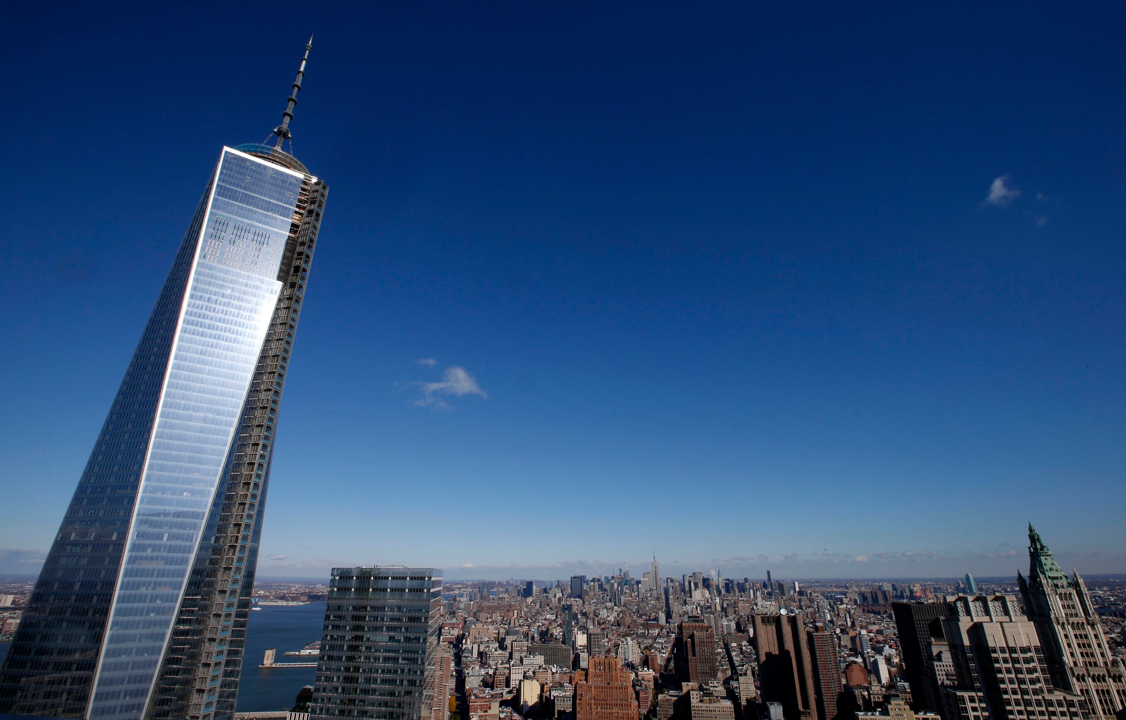 The One World Trade Center tower (L) is visible in this general view of Manhattan taken from the 57th floor of the soon to be opened 4 World Trade Center tower in New York, November 8, 2013. REUTERS/Mike Segar (UNITED STATES - Tags: CITYSCAPE TRAVEL)