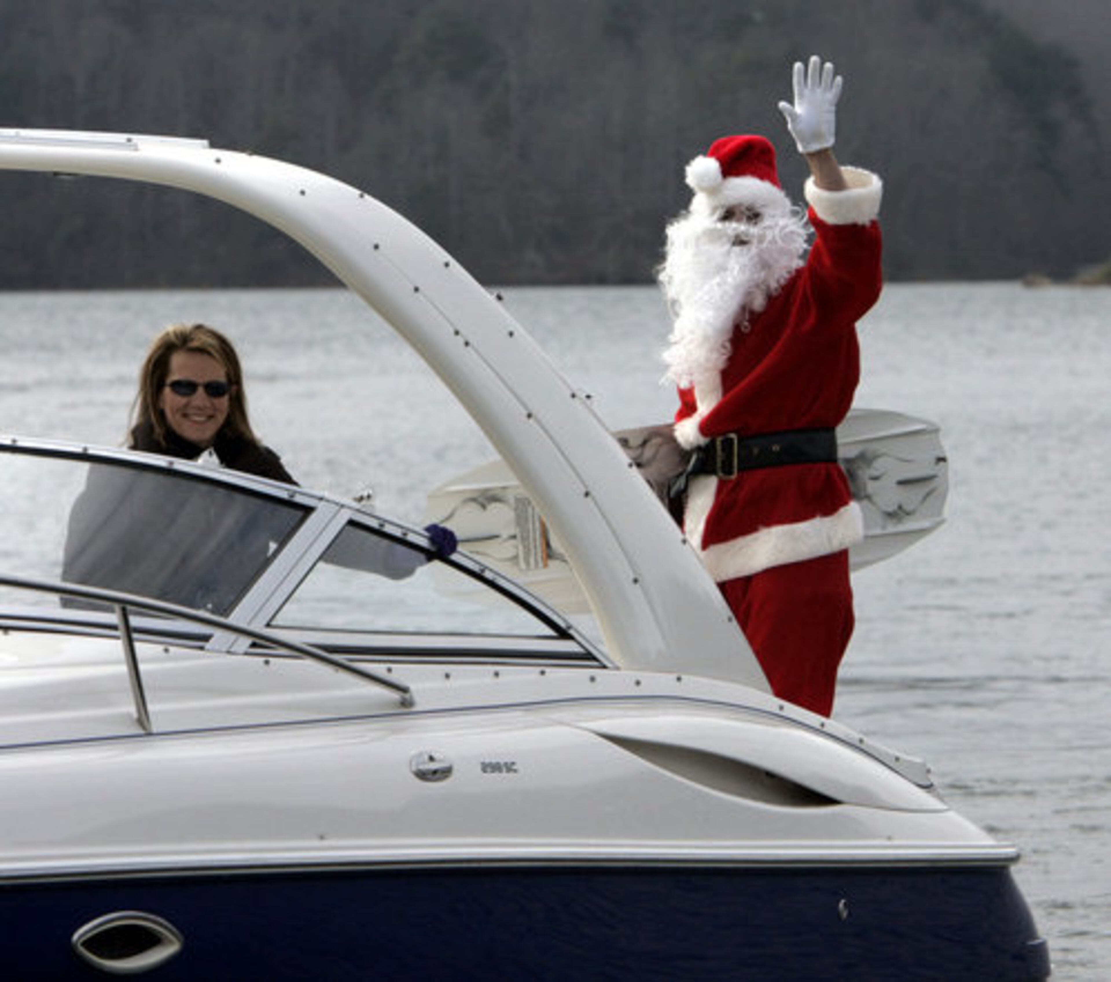 Mike Rolins water skis dressed as Santa near Six Mile Creek Park in Lake Lanier on Thursday, Dec. 24. Rolins and friends have carried on the tradition of skiing as Santa on Christmas eve for the past eight years. Rolins wore the full Santa suit, beard, hat, boots while wake boarding after a "dock starts" at the park.