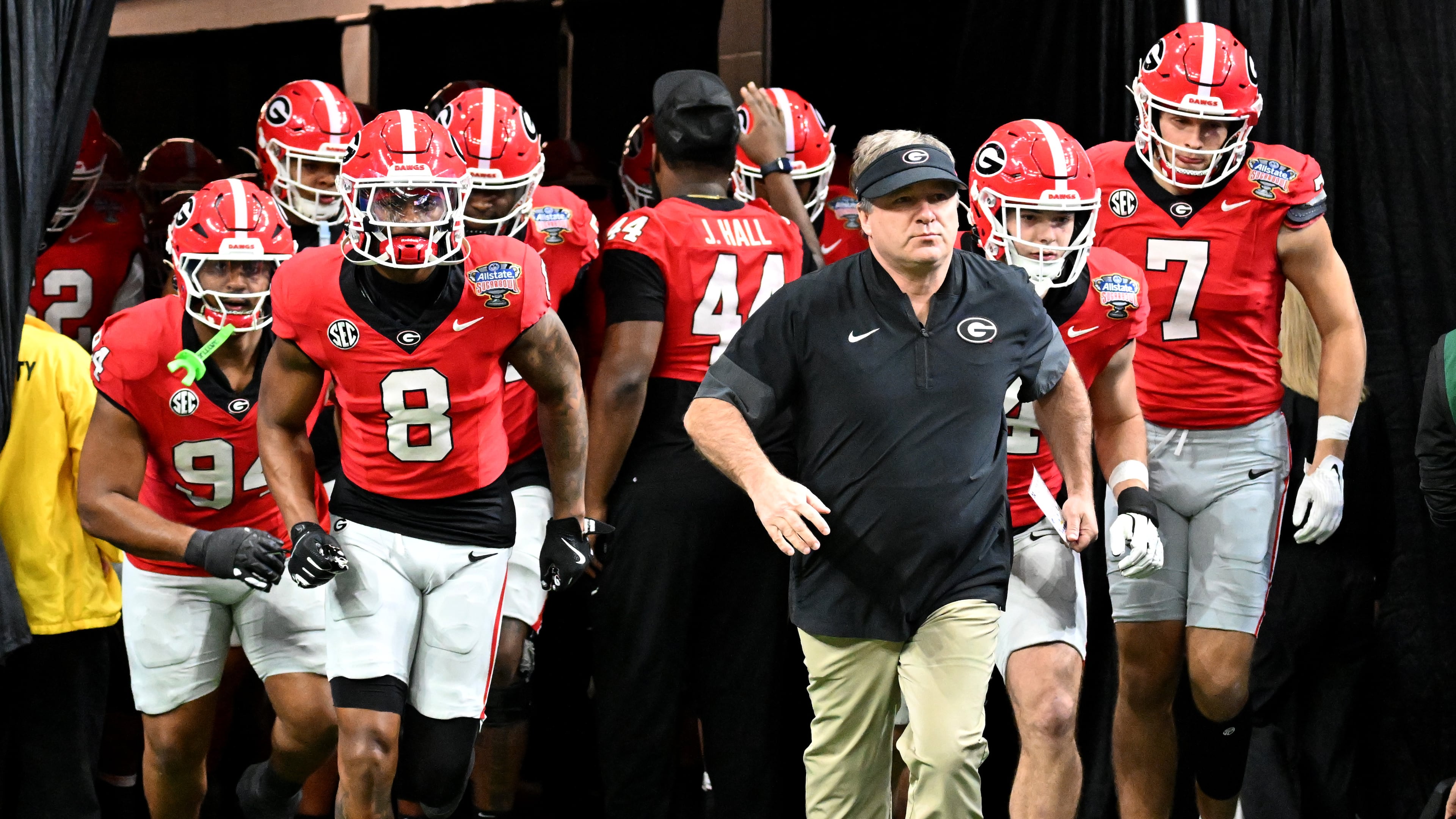 Georgia head coach Kirby Smart and players run onto the field for warm up before the Sugar Bowl against Ole Miss at the Caesars Superdome, Thursday, Jan. 1, 2026, in New Orleans. (Hyosub Shin/AJC)