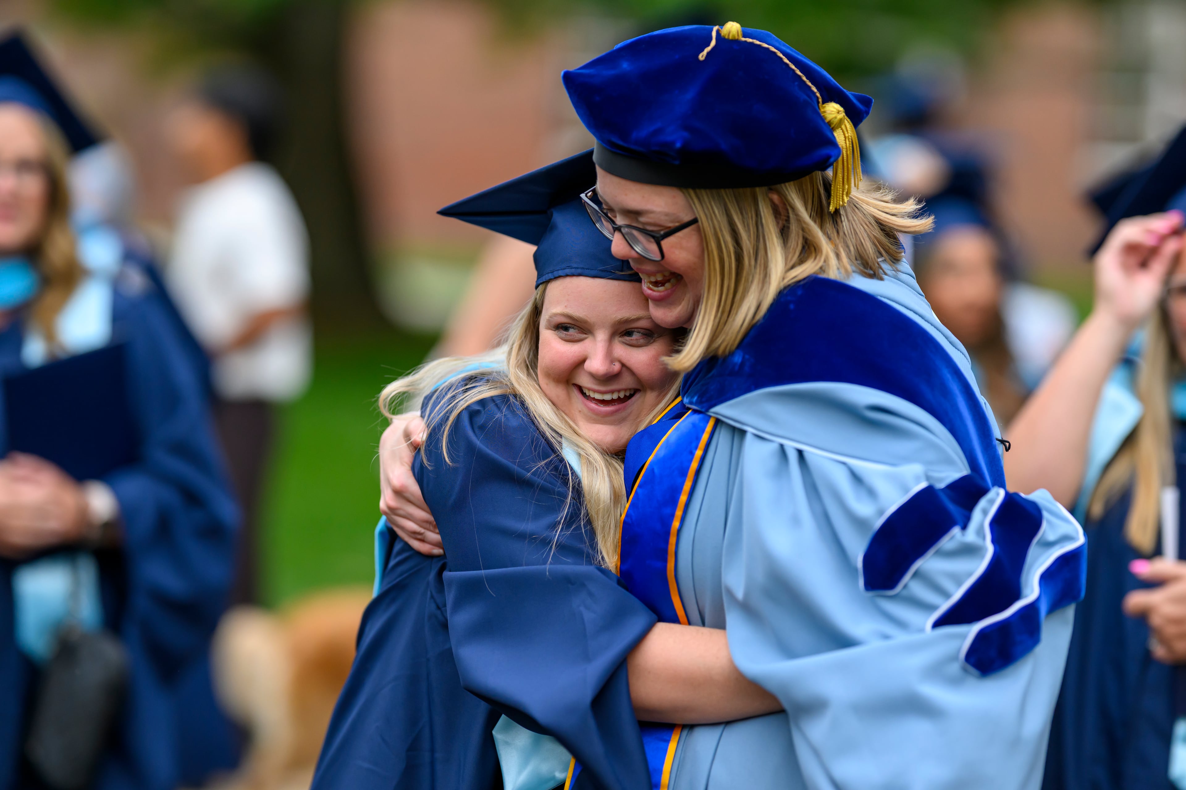 Berry College graduate Bryson Smith gets a hug from Lauren Heller, dean of the Campbell School of Business at Berry College, on Friday, May 8, 2026. The graduate commencement was held Friday, followed by the undergraduate commencement ceremony on Saturday. (Brant Sanderlin/Berry College)