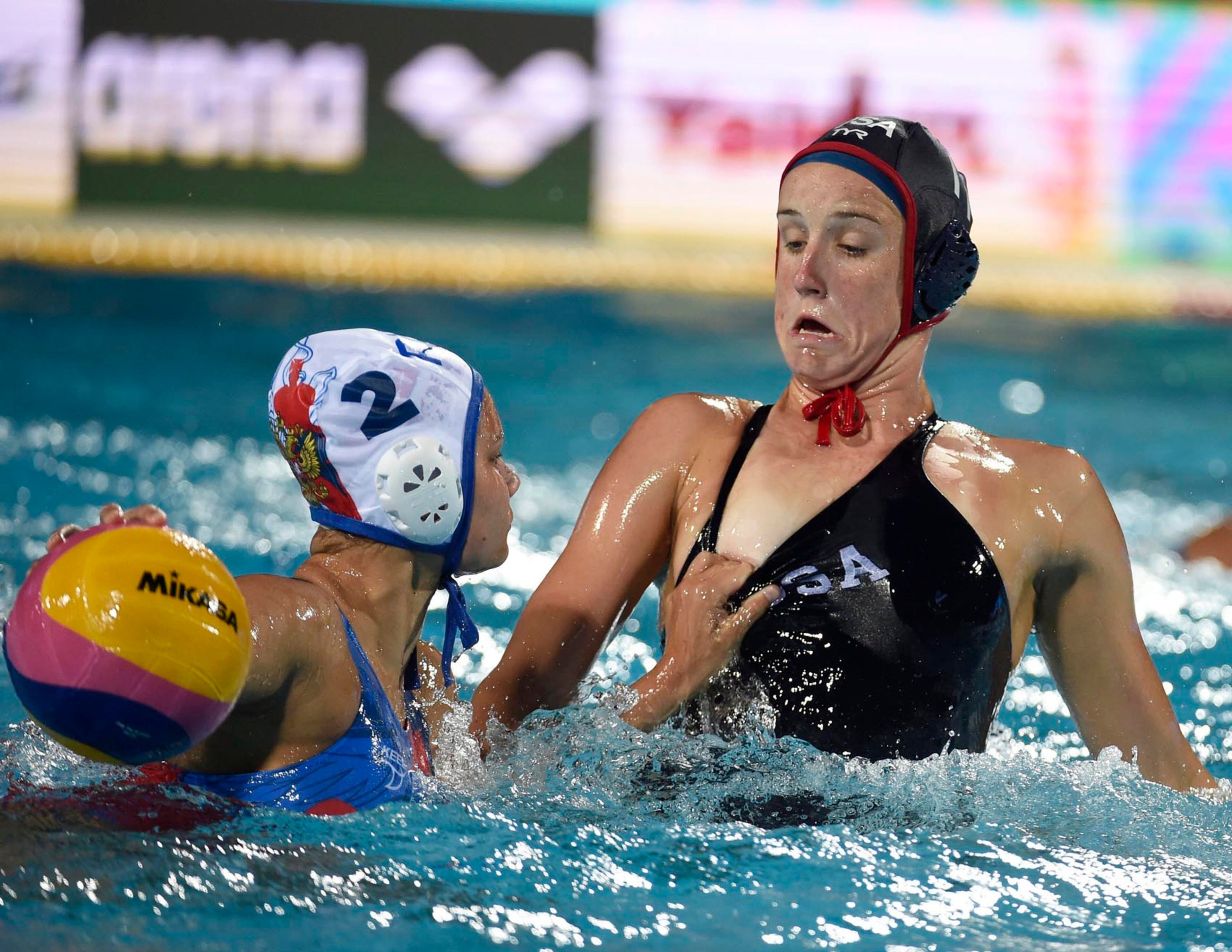Veronika Vakhitova, left, of Russia grabs the dress of Makenzie Fischer of the US during the women's water polo semifinal match Russia vs United States at the 17th FINA Swimming World Championships in Hajos Alfred National Swimming Pool in Budapest, Hungary, Tuesday, July 25, 2017. (Balazs Czagany/MTI via AP)