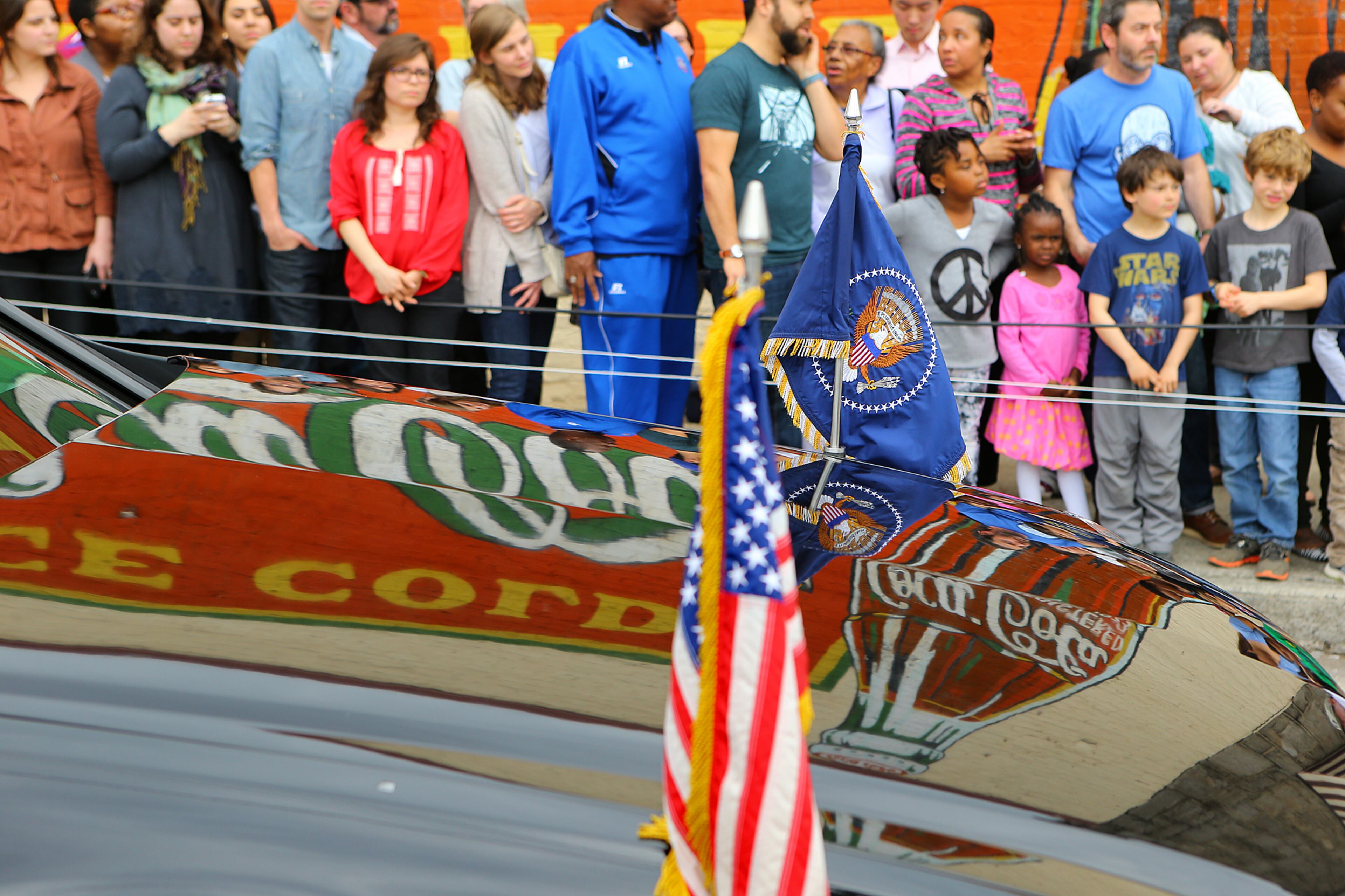 A Coca-Cola bottle is reflected on the hood of the Presidential limo "The Beast" as youngsters and others wait for President Barack Obama to leave Manuel's Tavern on Tuesday, March 10, 2015, in Atlanta. Curtis Compton / ccompton@ajc.com