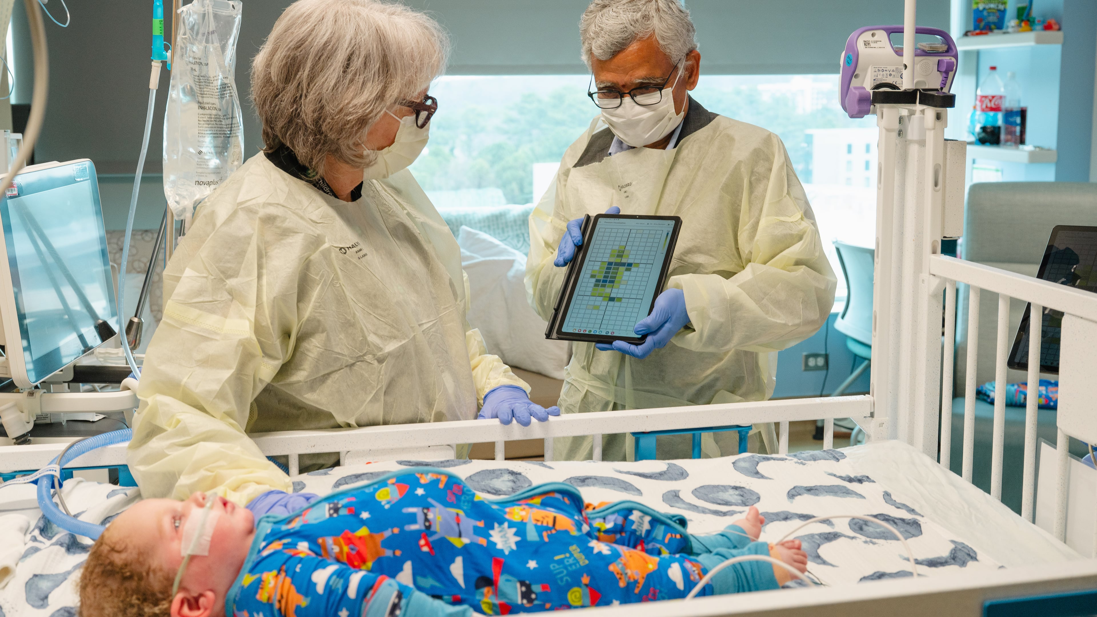 Dr. Jana Stockwell (left) and researcher Sundaresan Jayaraman discuss pilot testing a new pressure injury prevention system, using "smart" bedsheets. (Courtesy of Georgia Tech)
