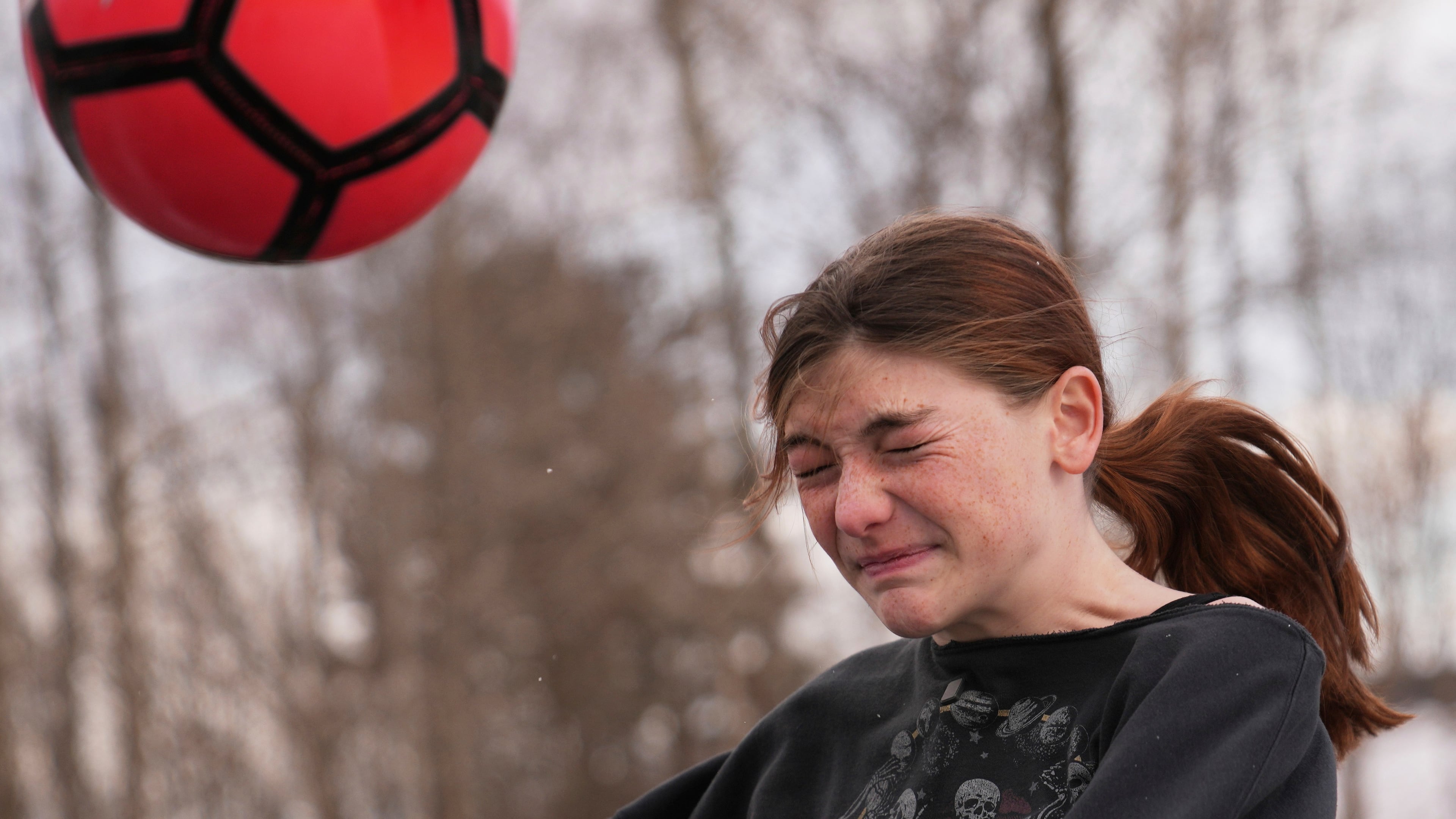 FILE - Parker Tirrell, a transgender athlete who plays on her high school's girls soccer team, heads the ball, Friday, March 7, 2025, in Plymouth, N.H. (AP Photo/Charles Krupa, File)