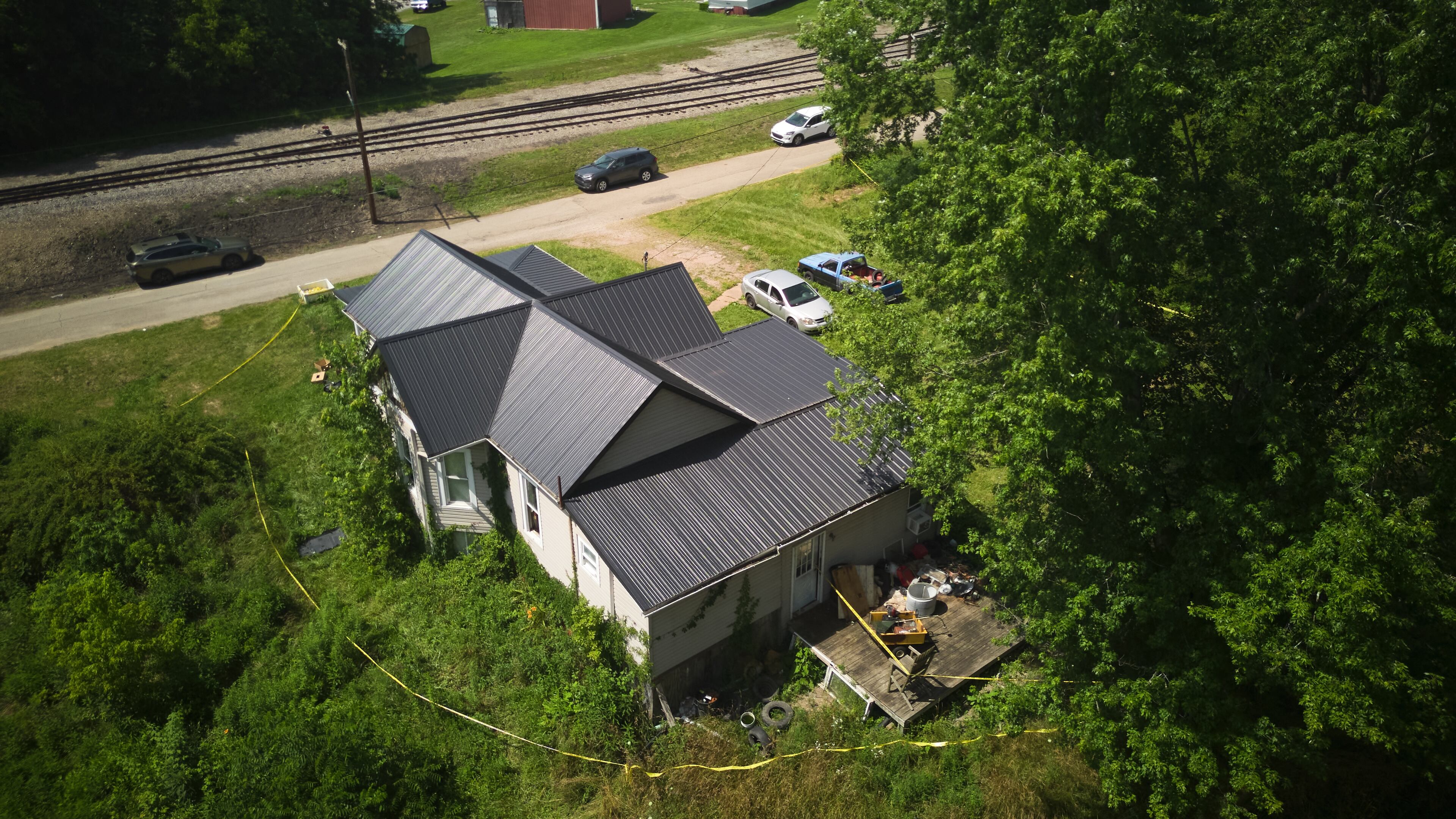 Police tape surrounds a home where authorities say they removed 16 children and arrested four adults in Hamden, Ohio, Wednesday, July 1, 2026. (AP Photo/Carolyn Kaster)