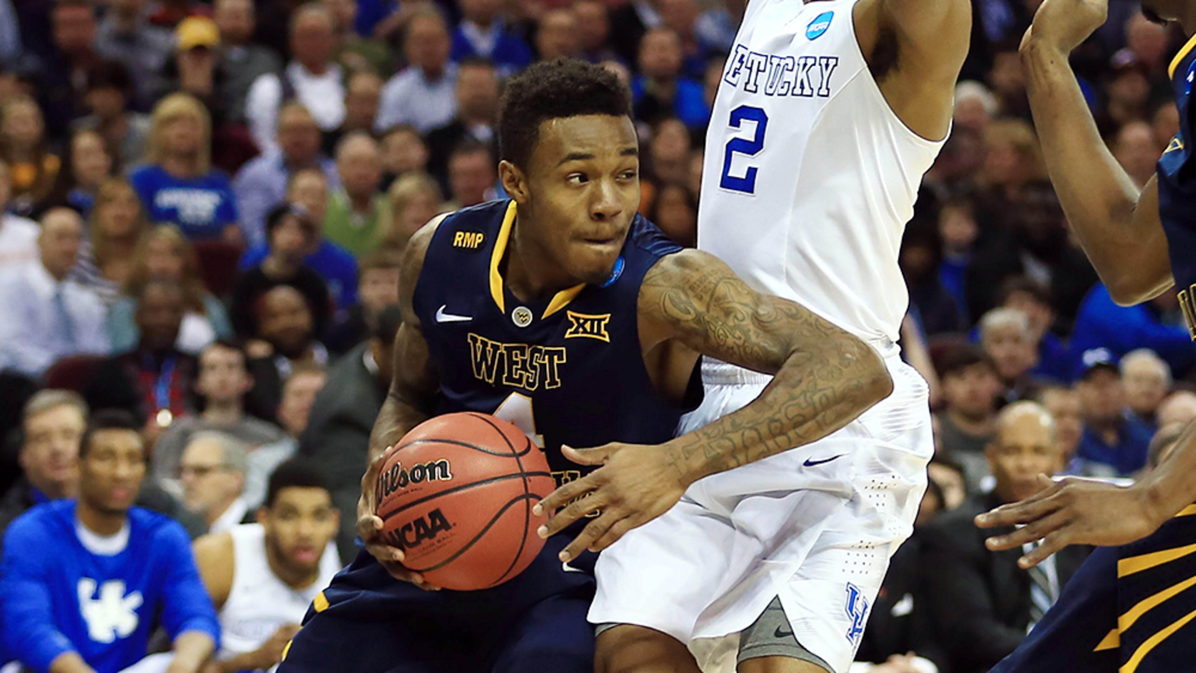 Mar 26, 2015; Cleveland, OH, USA; West Virginia Mountaineers guard Daxter Miles Jr. (4) works against Kentucky Wildcats guard Aaron Harrison (2) during the first half in the semifinals of the midwest regional of the 2015 NCAA Tournament at Quicken Loans Arena. Mandatory Credit: Andrew Weber-USA TODAY Sports