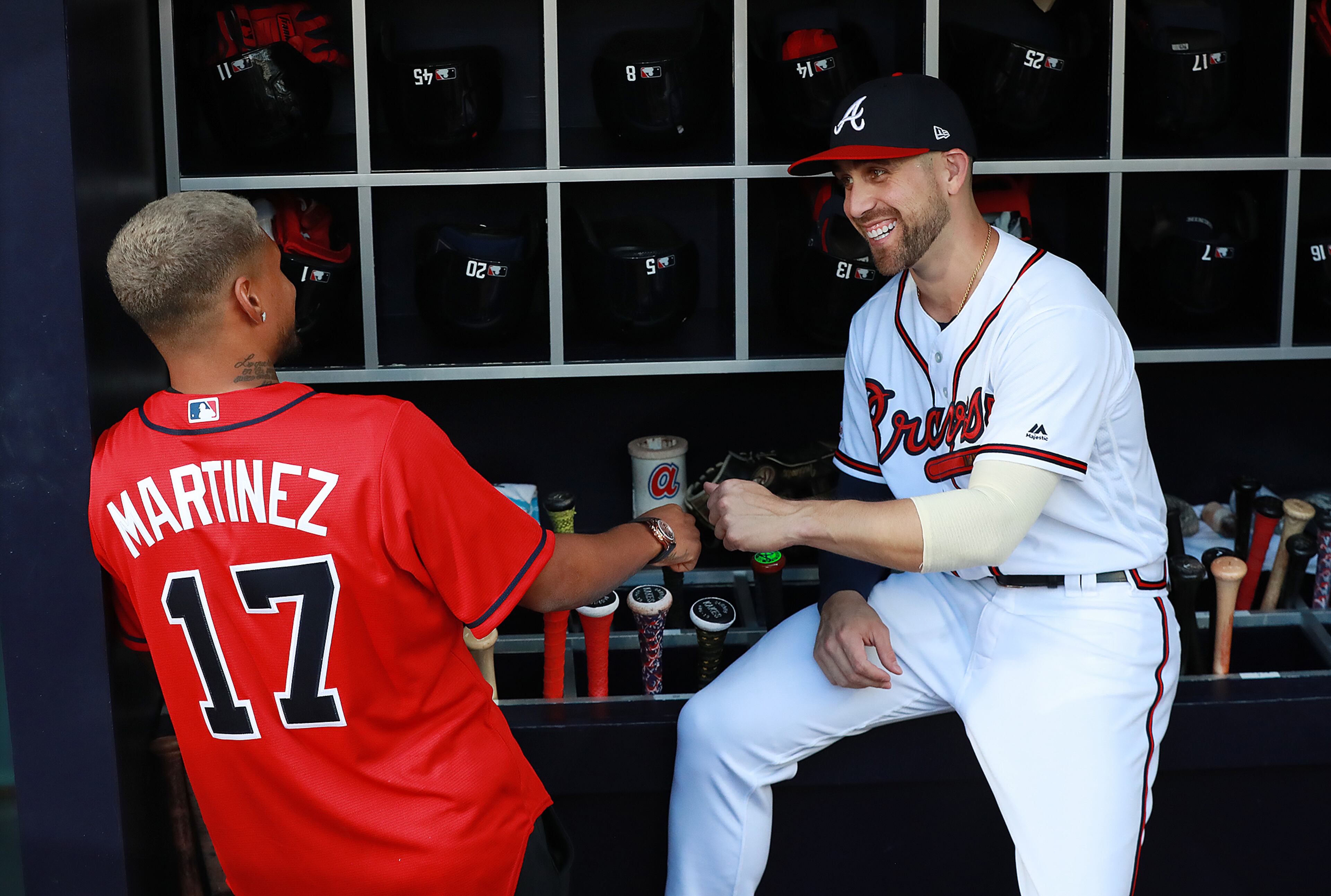 Braves' Ender Inciarte gives Atlanta United player Josef Martinez a fist bump in the dugout before the game. The Braves were recognizing Atlanta United for winning the MLS Cup. Curtis Compton/ccompton@ajc.com