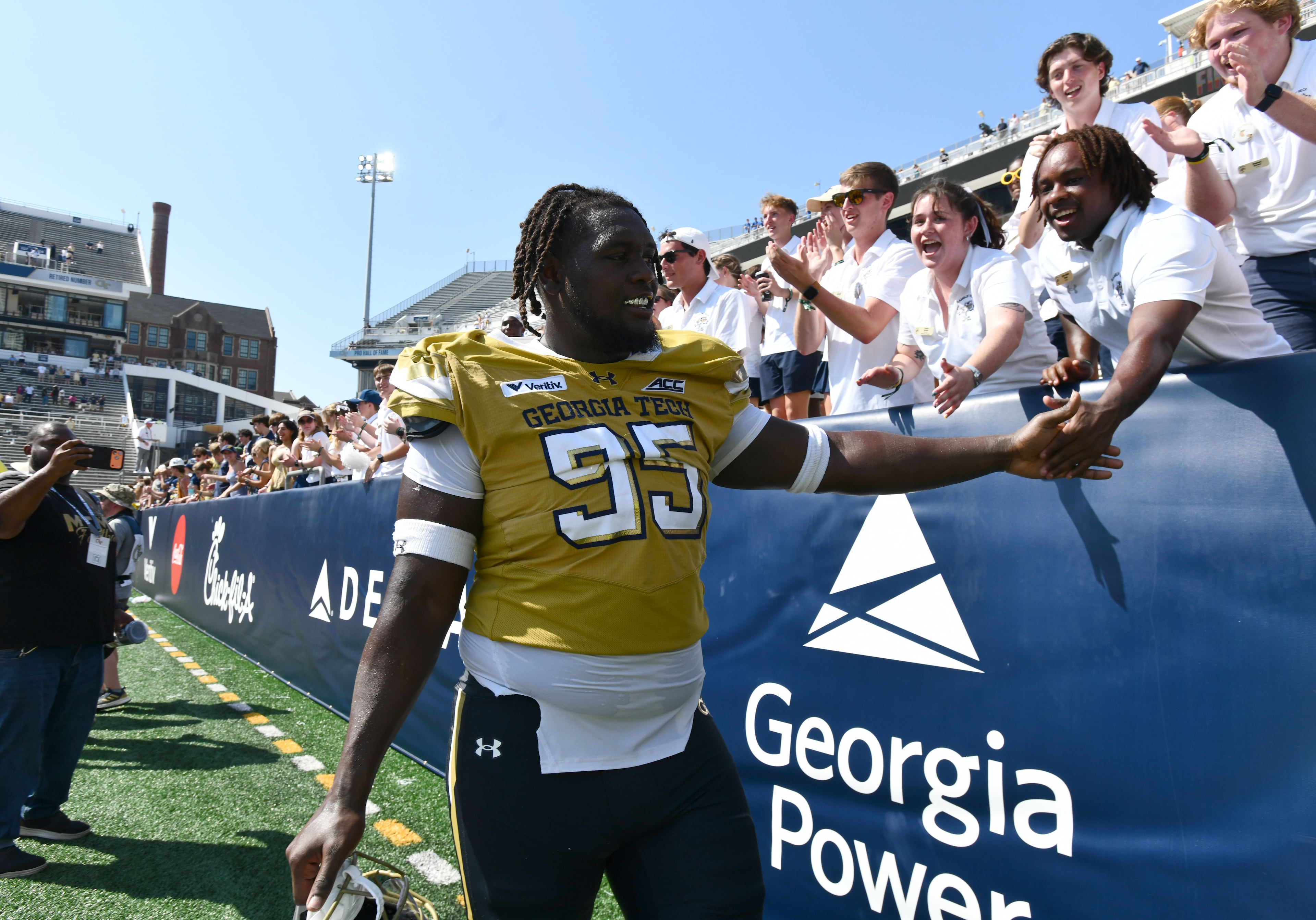 Georgia Tech defensive lineman Tawfiq Thomas (95) celebrates with fans after Georgia Tech defeated Mercer during the second half of an NCAA college football game at Bobby Dodd Stadium on Saturday, Sept. 19, 2026, in Atlanta. Georgia Tech defeated Mercer 44-11. (Hyosub Shin/AJC)