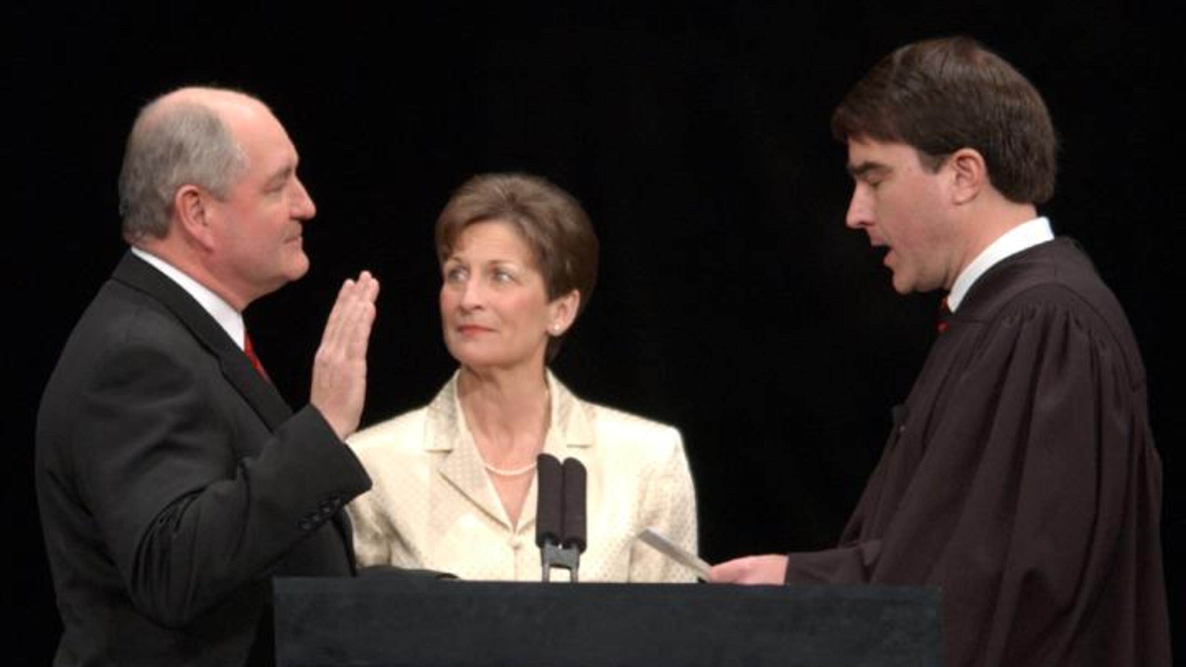 Gov. Sonny Perdue takes the oath of office in 2003, administered by the Judge Clay D. Landas his wife Mary Perdue watches. AJC file