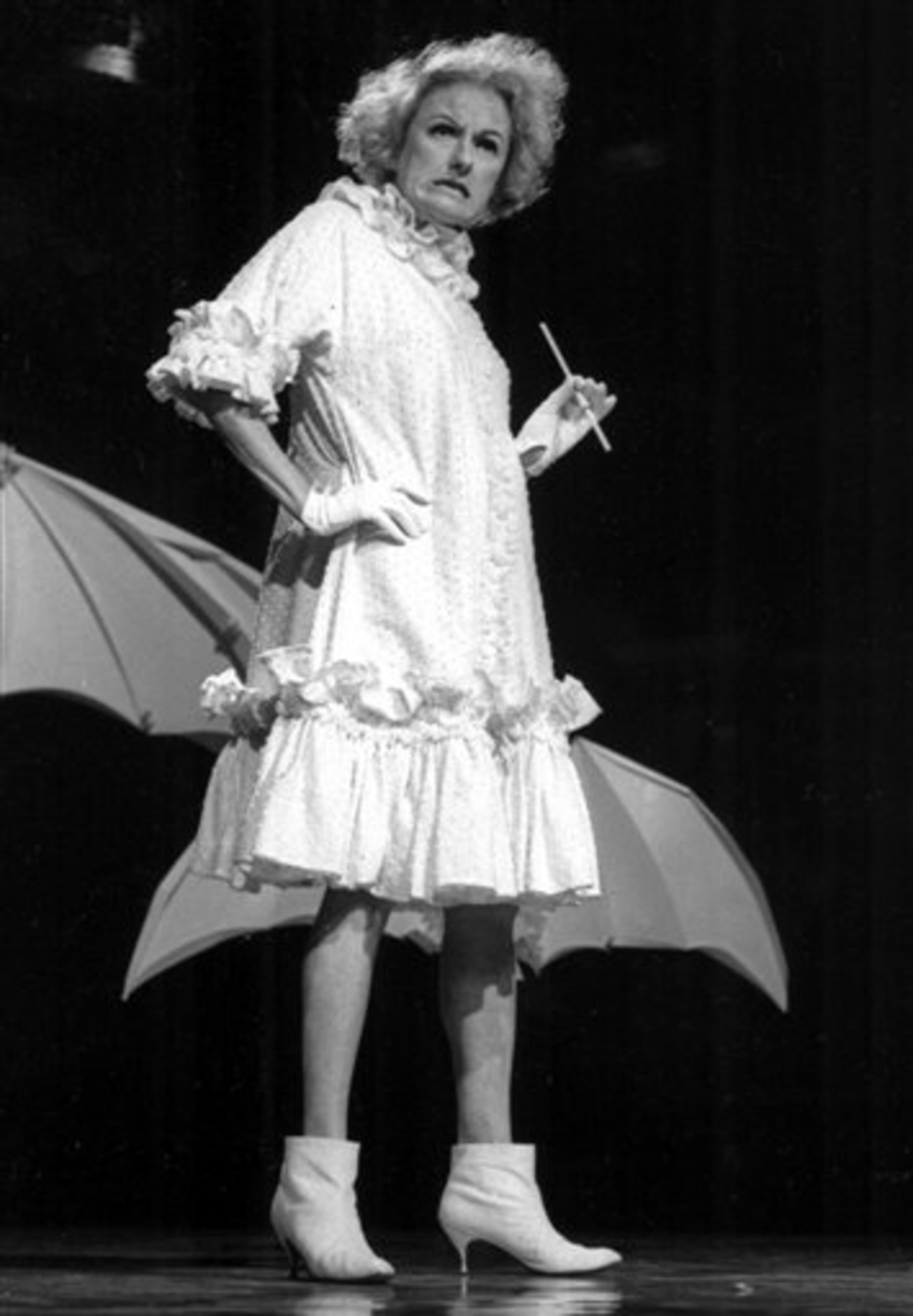 FILE-In this undated file photo, Comedian Phyllis Diller performs in character. Diller, the housewife turned humorist who aimed some of her sharpest barbs at herself, died Monday, Aug. 20, 2012, at age 95 in Los Angeles. (AP Photo/NBC-TV, File)