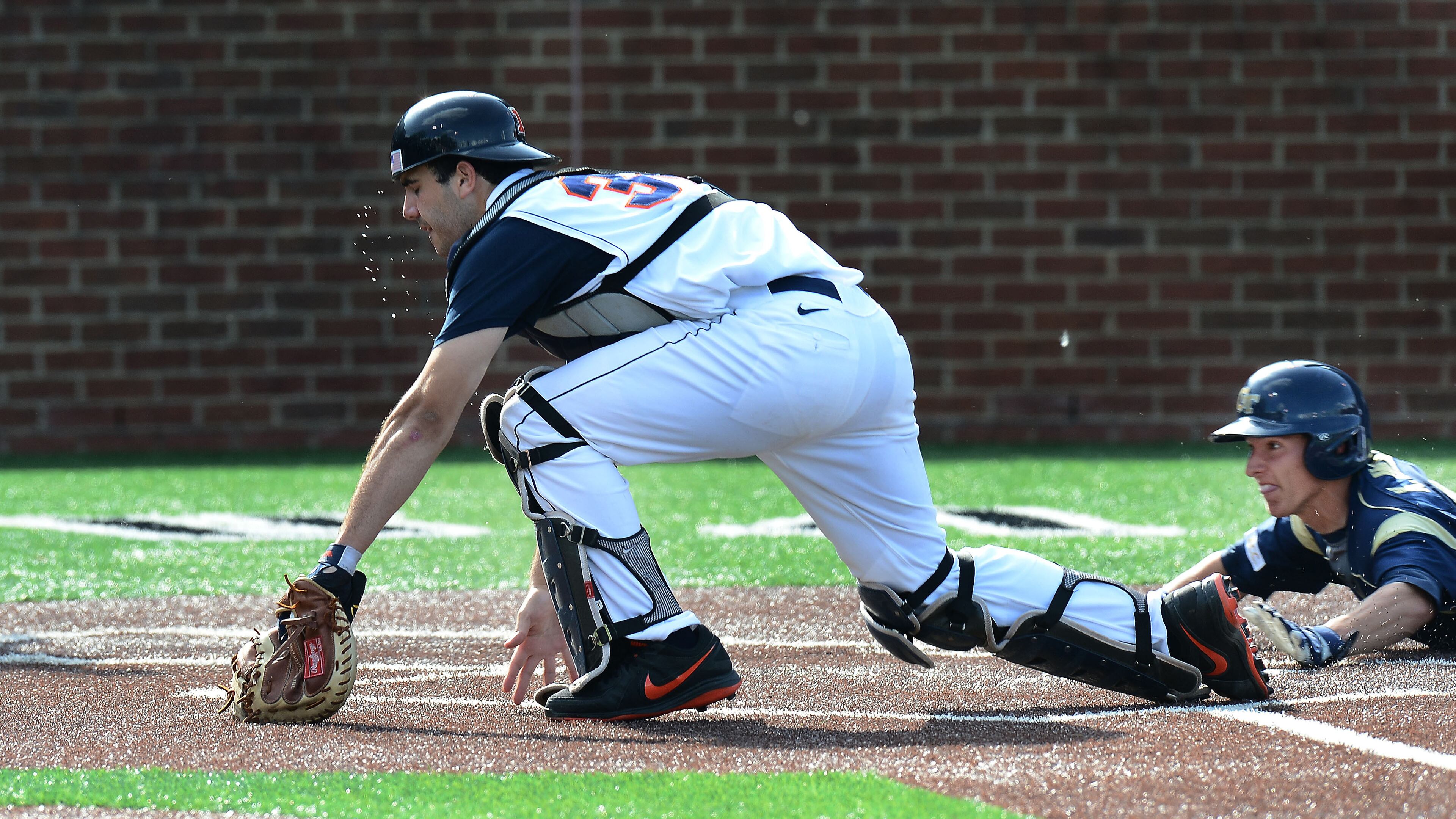 Illinois catcher Jason Goldstein (36) chases down the ball as Georgia Tech's Kyle Wren, right, scores the go-ahead run on a triple hit by Georgia Tech's Cole Pitts in the ninth inning of an NCAA college baseball tournament regional game on Sunday, June 2, 2013, in Nashville, Tenn. (AP Photo/Mark Zaleski)
