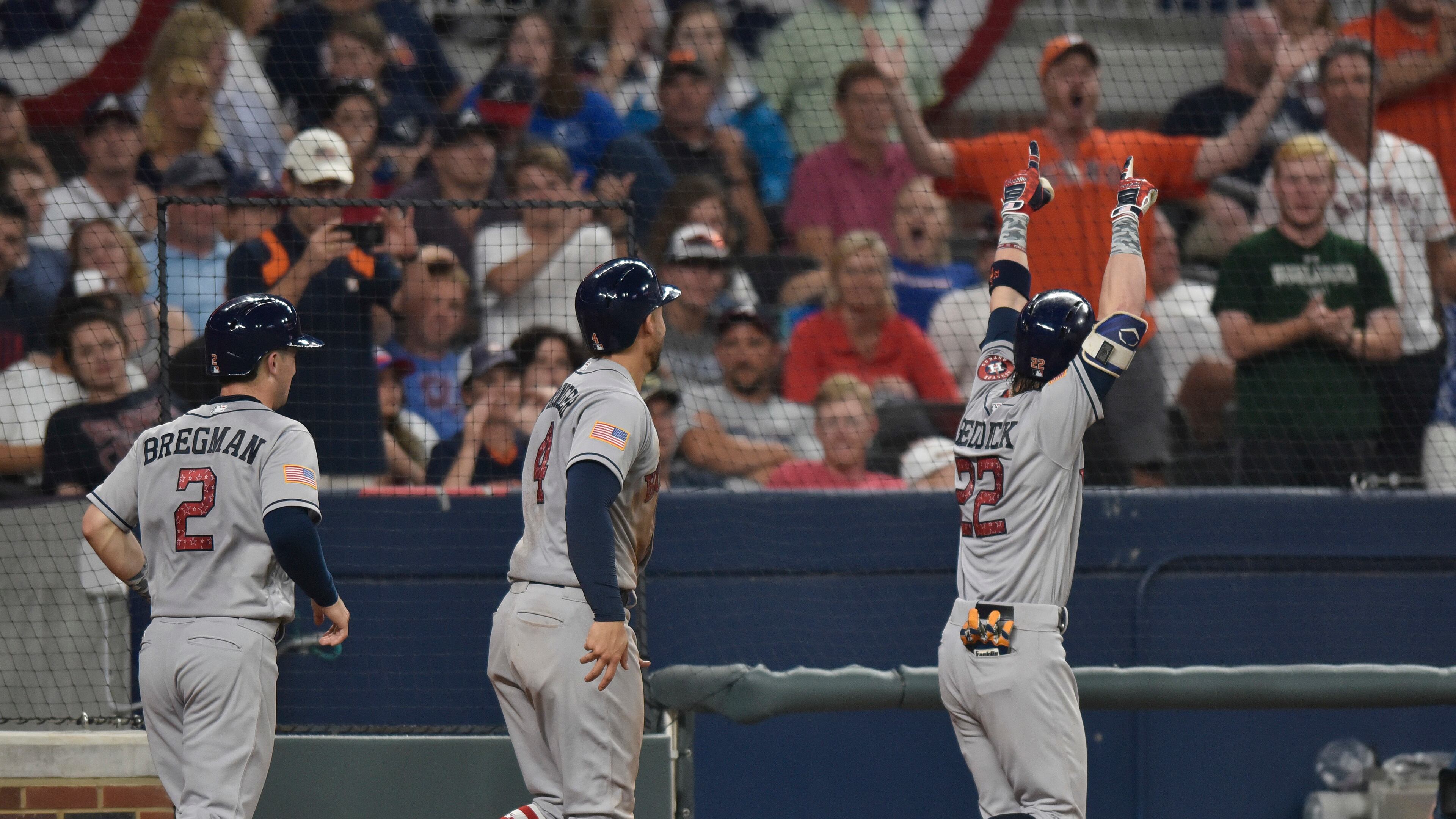 Houston Astros fans cheers as Houston Astros Josh Reddick celebrates a three run homer during the 9th inning of a baseball game against the Atlanta Braves, Tuesday, July 4, 2017, in Atlanta. (AP Photo/Richard Hamm)