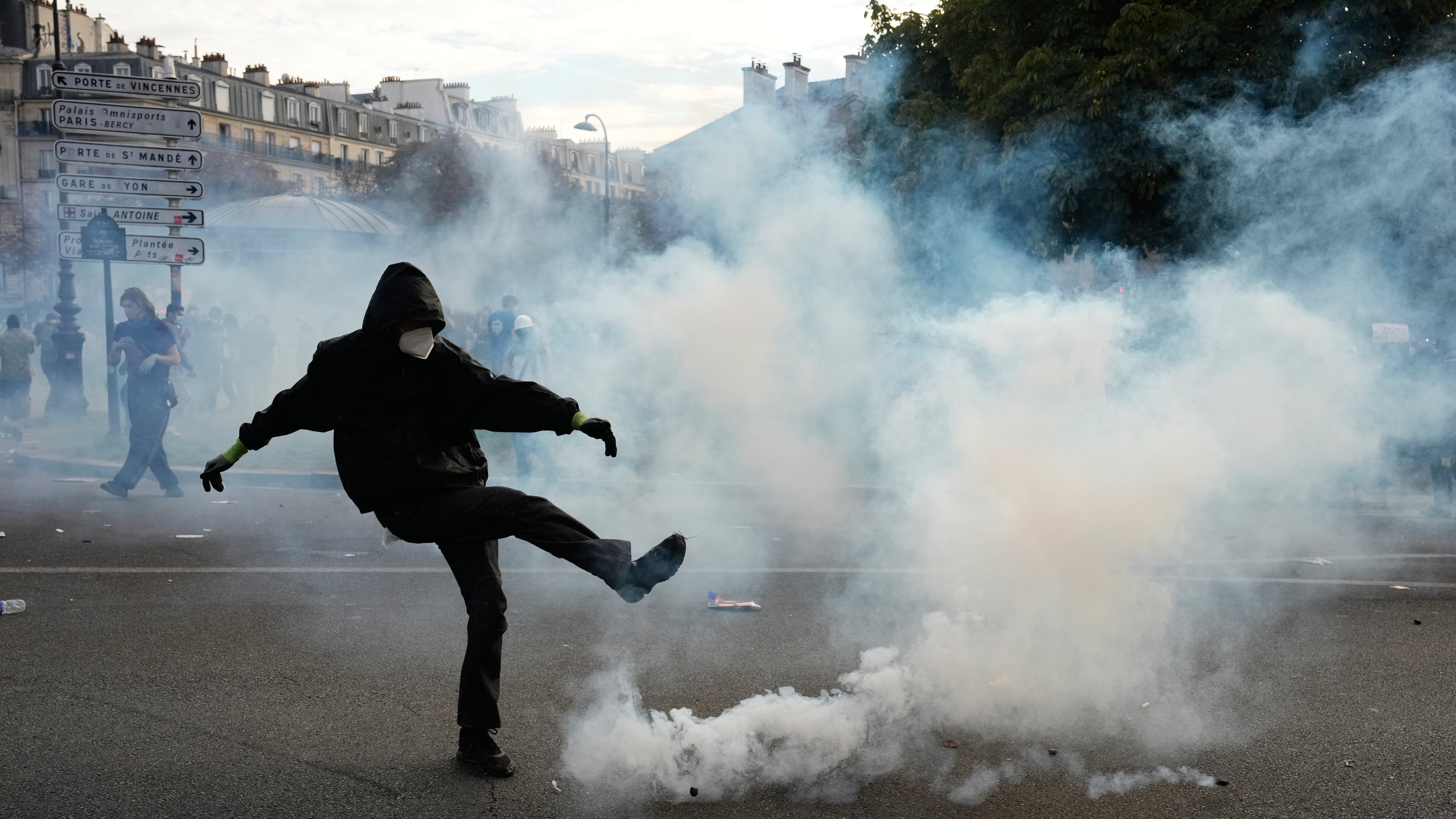 A protesters kicks a teargas canister during scuffles following a demonstration against under-resourced schools, in Paris, Tuesday, Oct. 6, 2026. (AP Photo/Teresa Suarez)