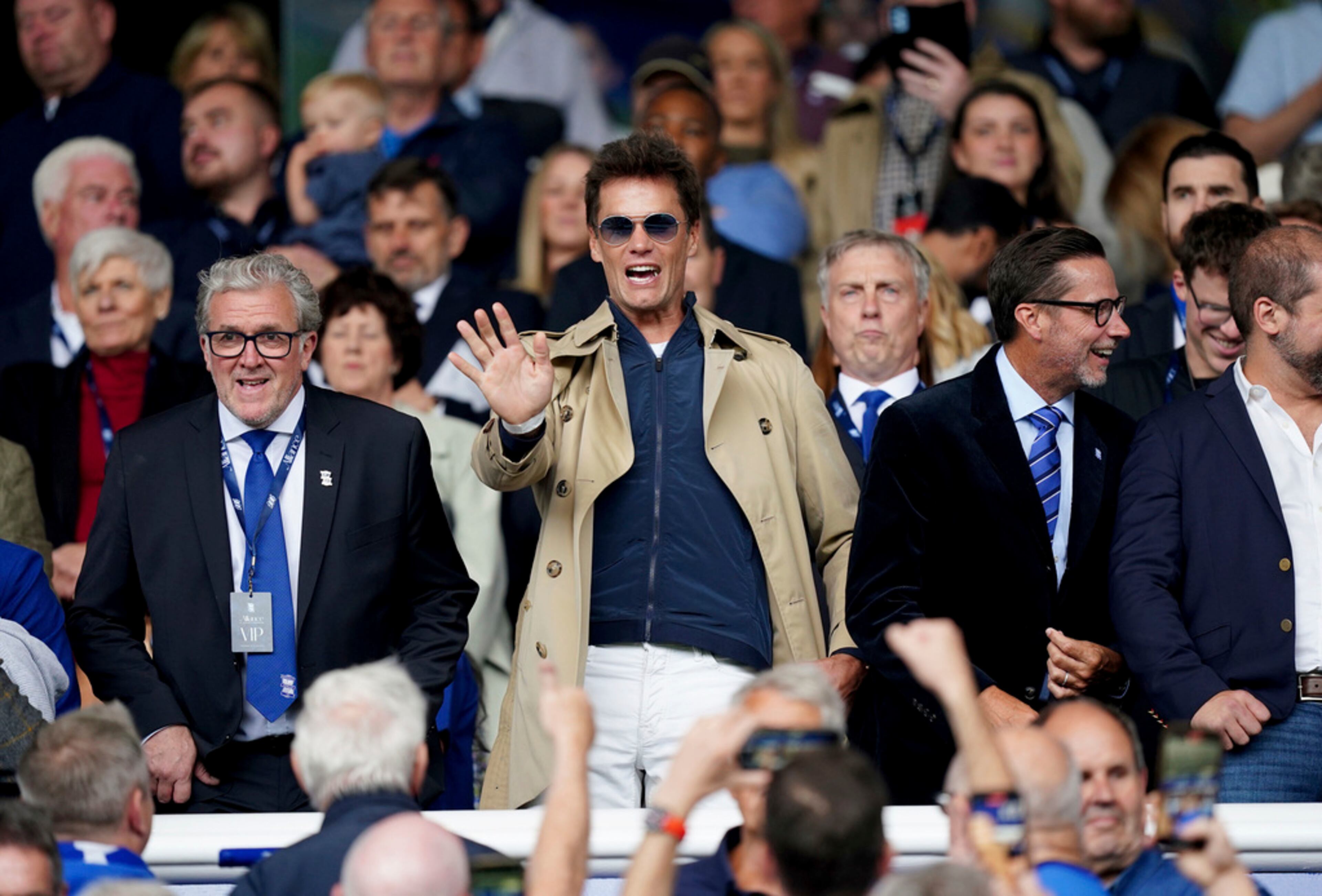Birmingham City co-owner Tom Brady, center, CEO Garry Cook, left, and director Matt Alvarez, right, in the stands before the Championship soccer match between Birmingham City and Leeds United at St. Andrew's, Birmingham, England, Saturday Aug. 12, 2023. (Mike Egerton/PA via AP)