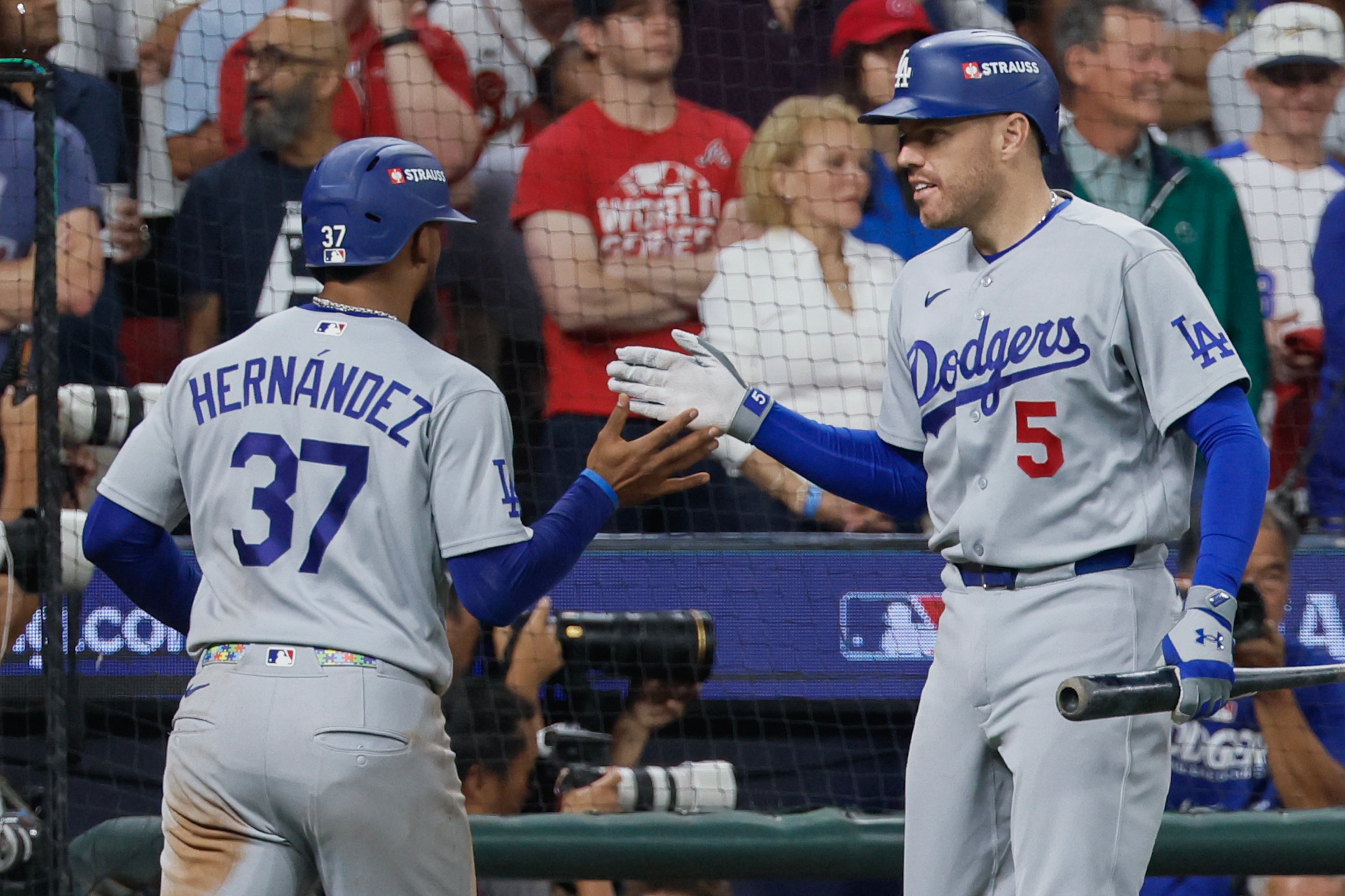 Los Angeles Dodgers' Freddie Freeman (5) greets Teoscar Hernandez (37) after scoring against the Atlanta Braves during the seventh inning of Game 4 of the MLB National League Division Series between the Atlanta Braves and the Los Angeles Dodgers, Wednesday, Oct. 7, 2026, in Atlanta. (Miguel Martinez/AJC)
