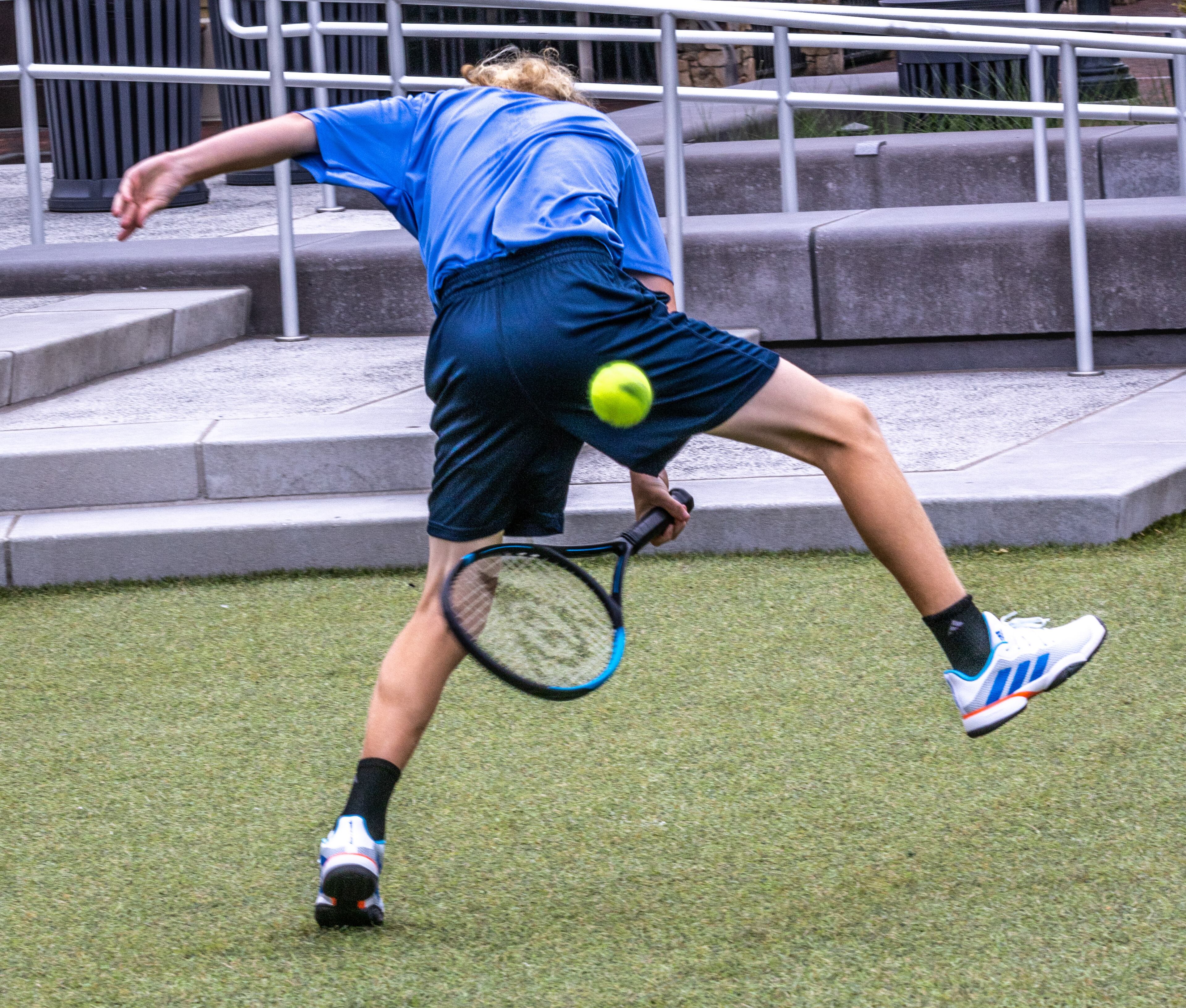 Everett Meinhardt returns a ball between his legs while volleying with other Official Ball kids before the start of the Atlanta Open Media Day at Atlantic Station Tuesday, June 28, 2022. (Steve Schaefer / steve.schaefer@ajc.com)