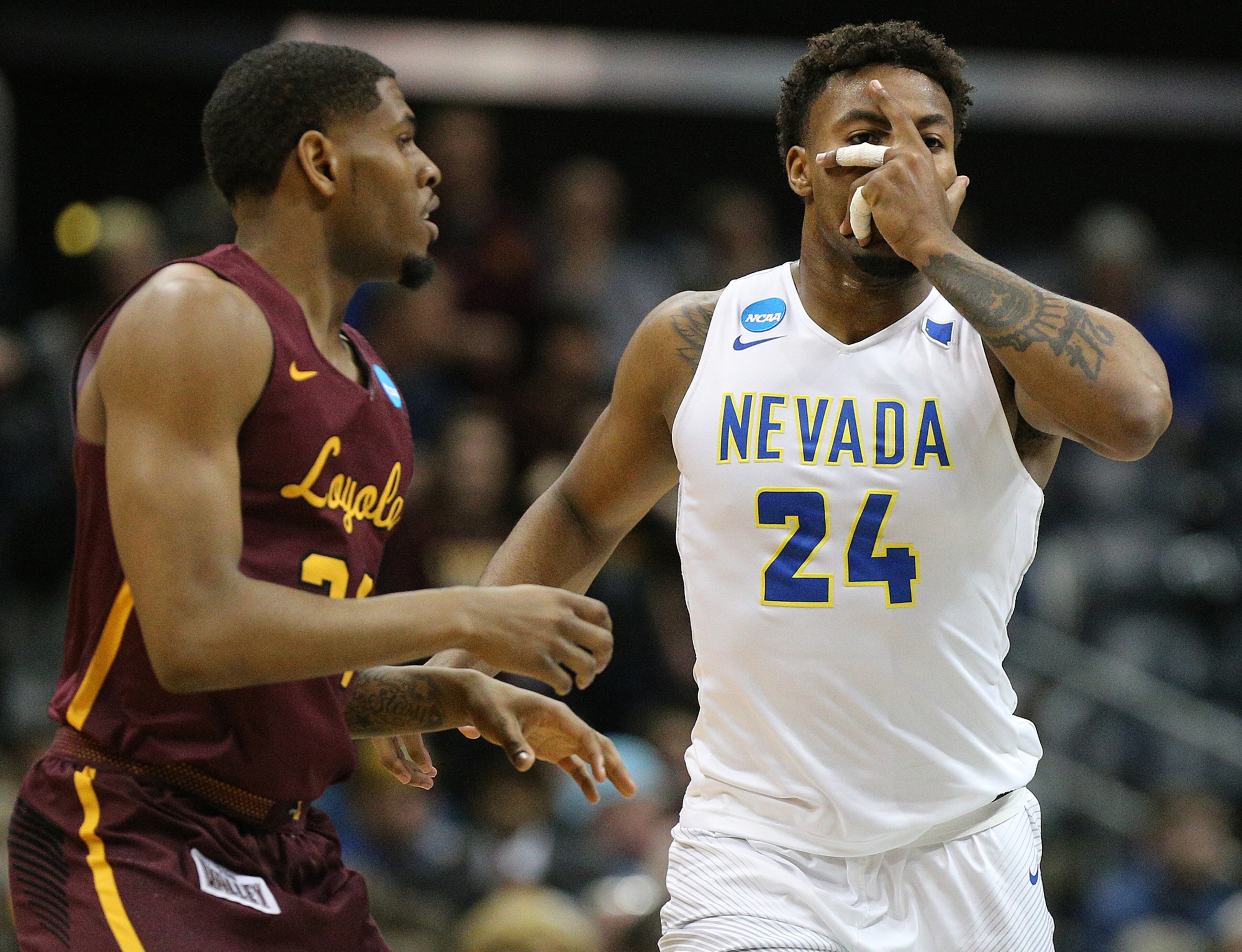 March 22, 2018 Atlanta: Nevada forward Jordan Caroline reacts to hitting a three pointer against Loyola forward Aundre Jackson during the first half of a regional semifinal NCAA college basketball game on Thursday, March 22, 2018, in Atlanta. Curtis Compton/ccompton@ajc.com
