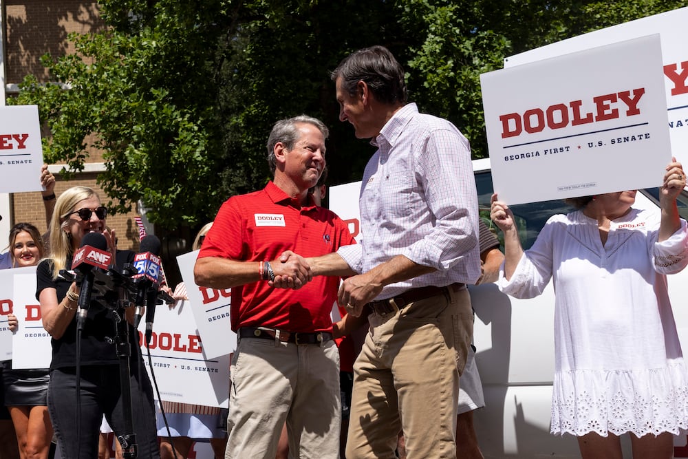 Gov. Brian Kemp (left) greets Derek Dooley, a Republican candidate for U.S. Senate in Georgia, during a campaign stop last year. (Jason Getz/AJC)