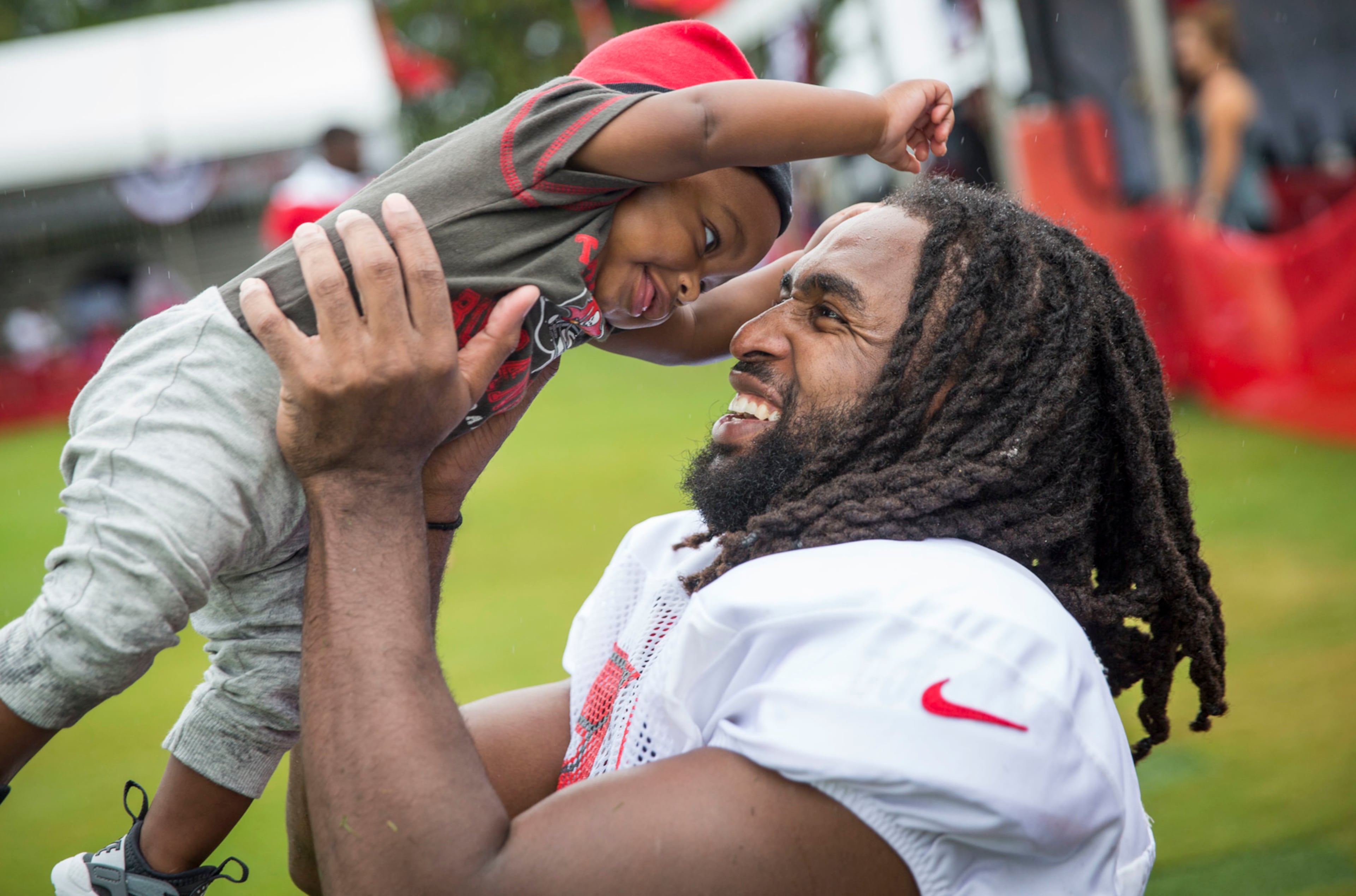 Tampa Bay Buccaneers defensive back J.J. Wilcox (27) holds son James Wilcox III, 7 months, after practice at training camp at One Buccaneer Place in Tampa, Fla., on Monday, July 31, 2017. (Loren Elliott /Tampa Bay Times via AP)