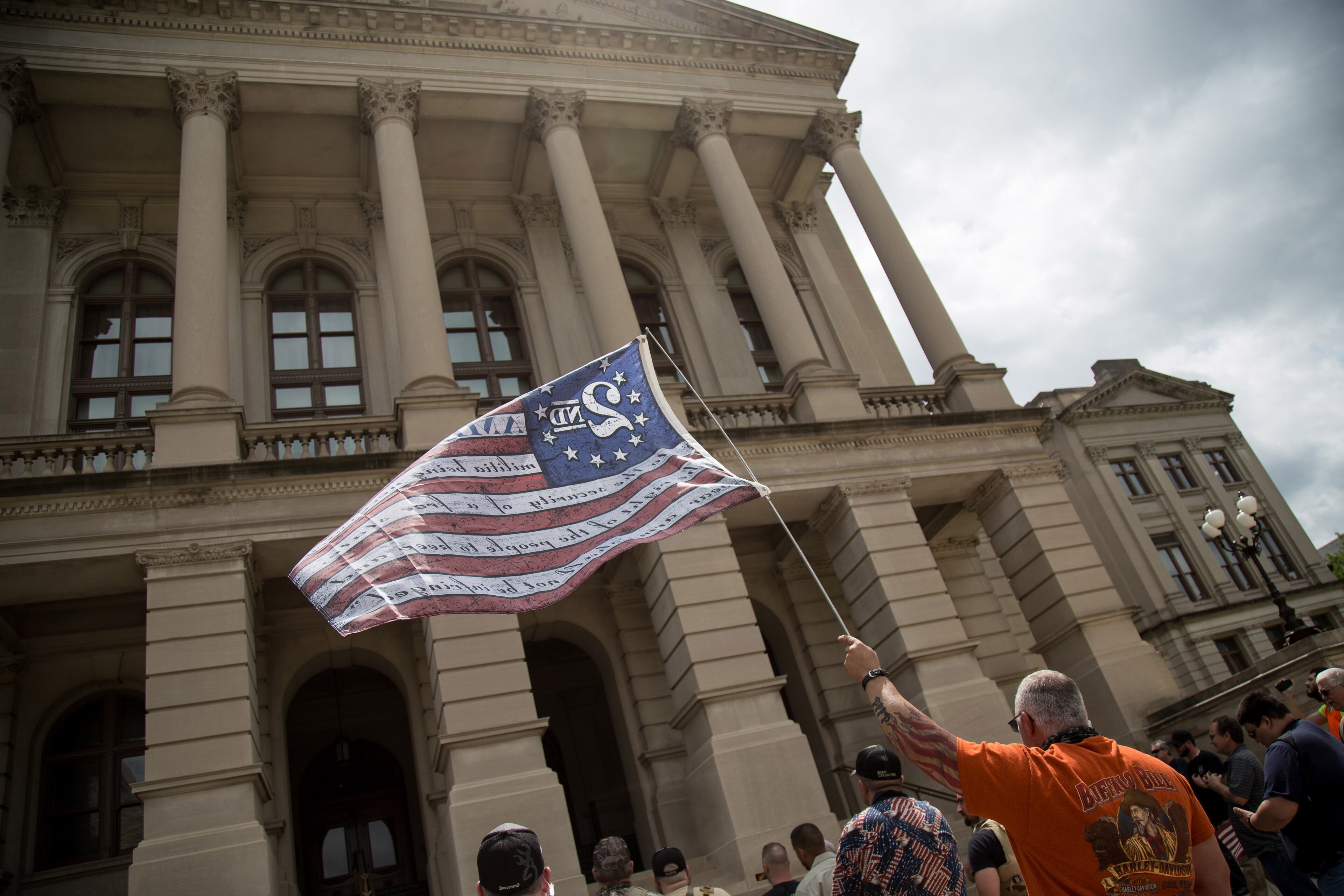 David Moor holds up a flag at a gun rights rally at the state Capitol in Atlanta on Saturday, April 14, 2018. STEVE SCHAEFER / SPECIAL TO THE AJC