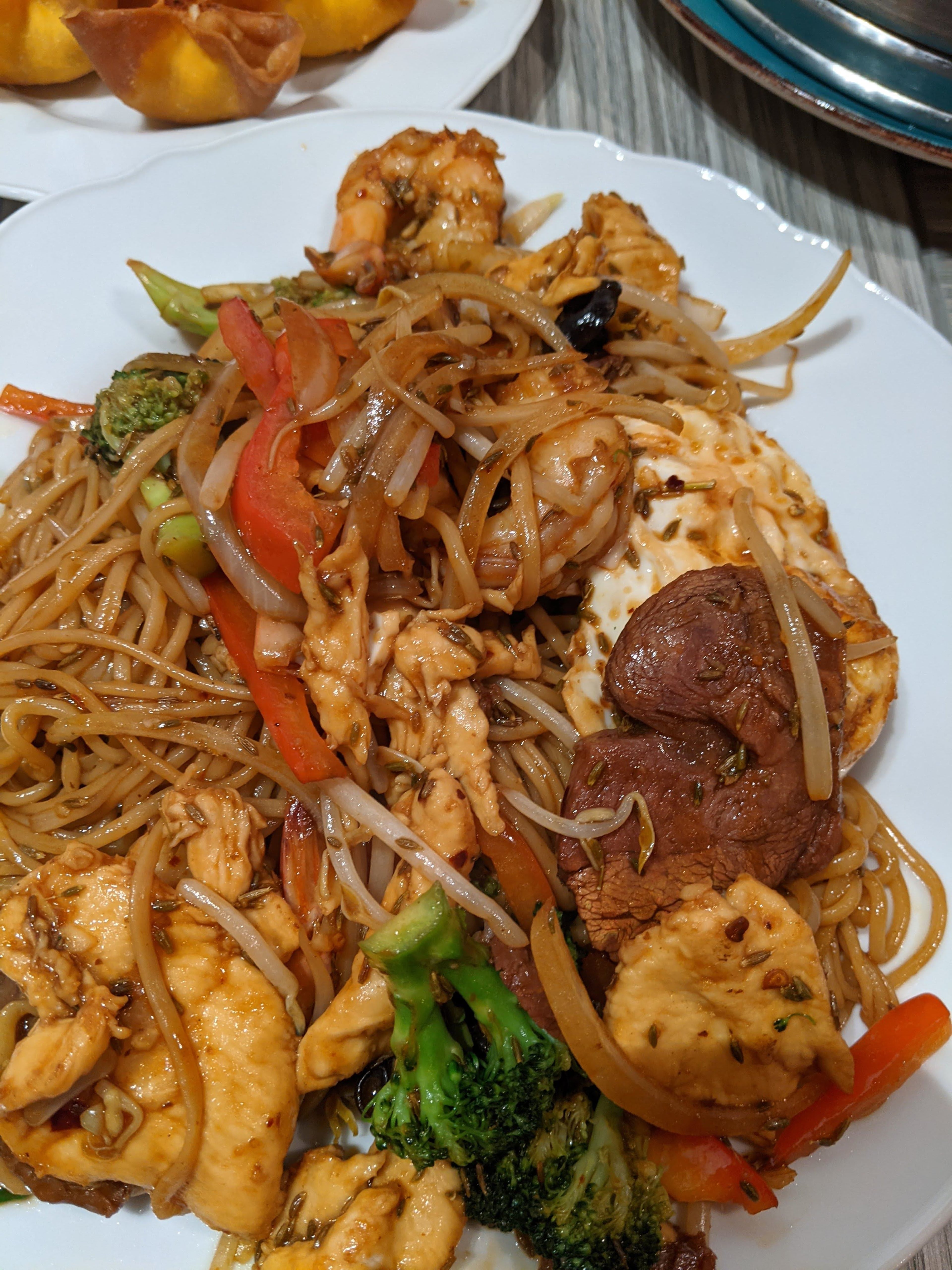Stir-fried, medium-thickness, hand-pulled noodles with chicken, roast pork and assorted vegetables from 3+3 Lanzhou Ramen. (Su-Jit Lin for the AJC)