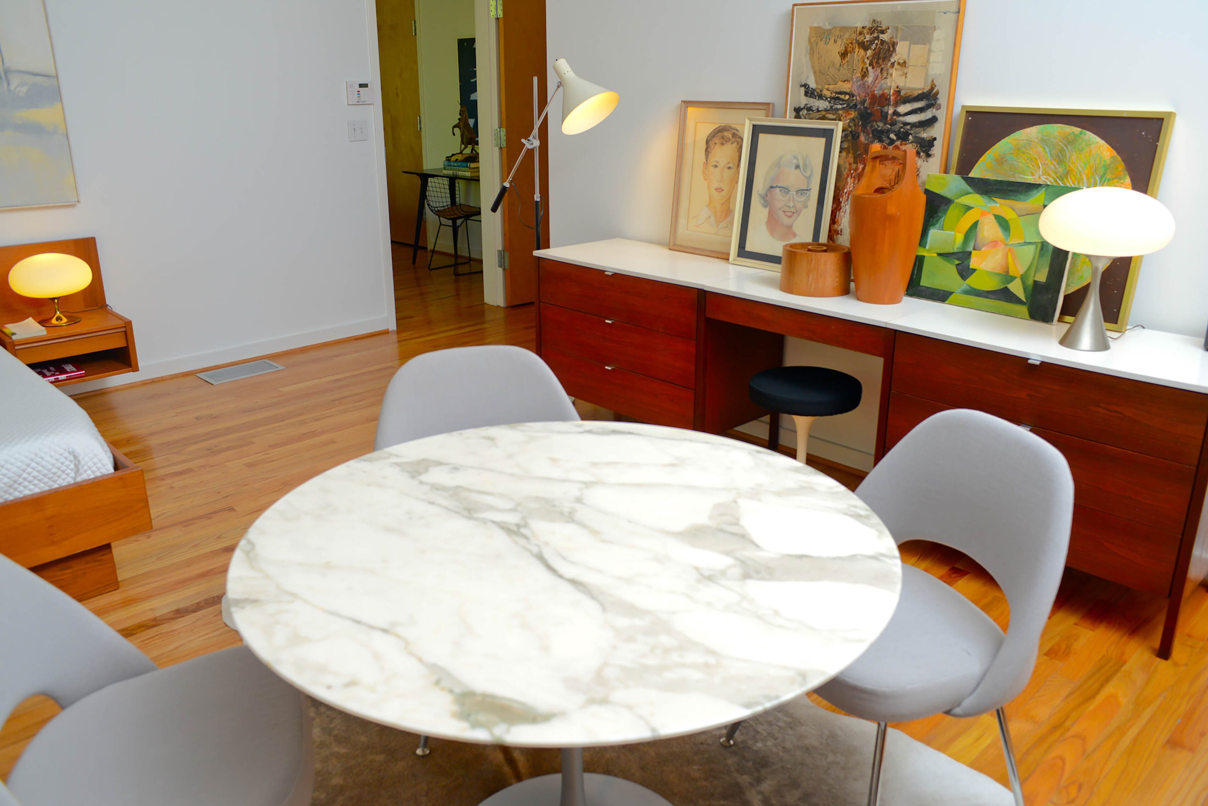 The open master bedroom is spacious enough to feature a separate sitting area, as well as a dining table and chairs. Throughout the home, Henry effortlessly blends an eclectic mix of colorful and clean modern pieces into a modern art deco style all his own.
