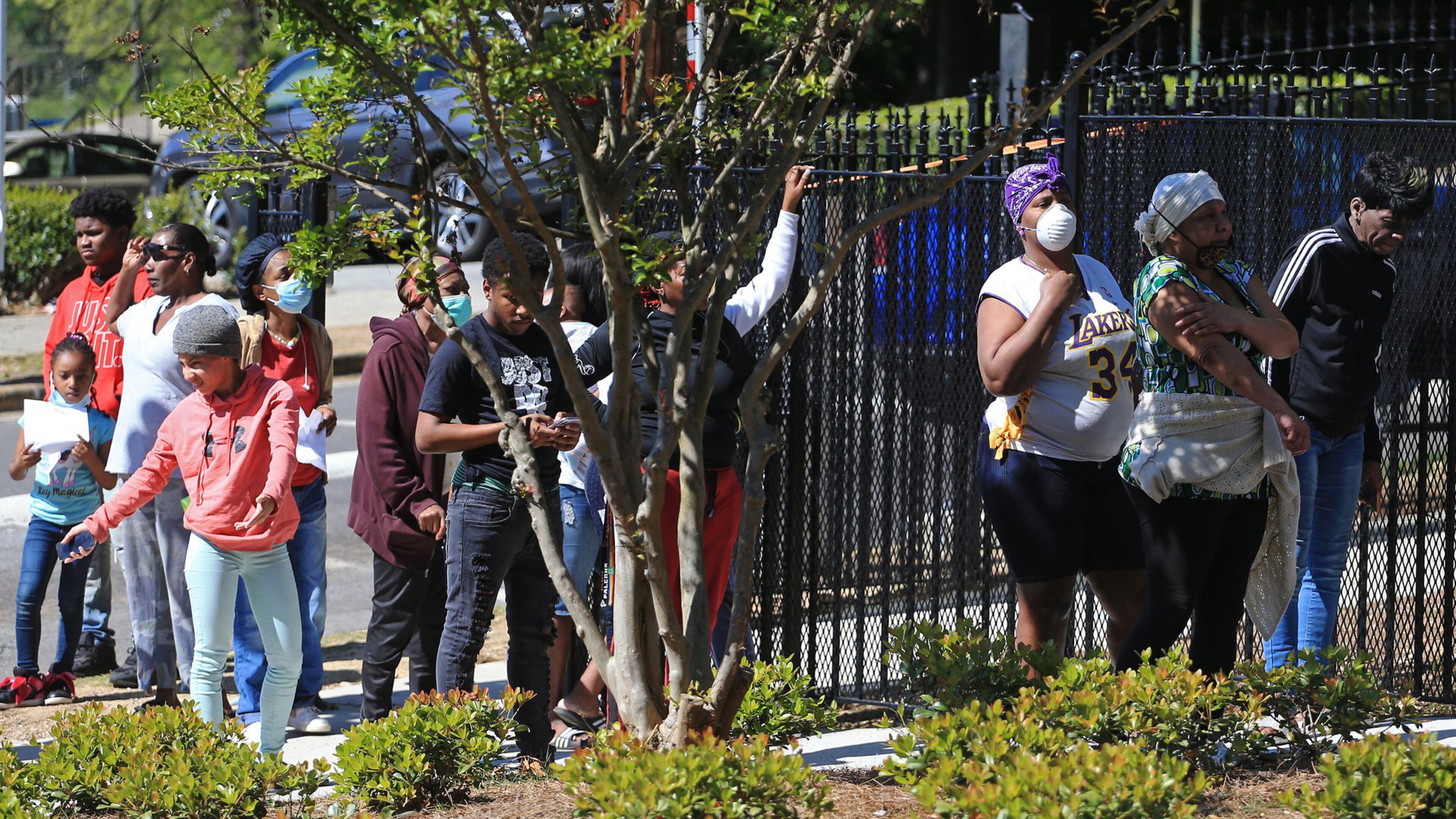 Residents at Allen Hills apartments line up to receive food during the Grab and Go free food and groceries event on Friday, April 17, 2020, at Allen Hills Apartments in Atlanta. Fulton County prosecutors Shari Jones, Brandon Pierre Thomas and Terrell Thomas are part of a community effort to distribute grocery items at Allen Hills. (Christina Matacotta, for The Atlanta Journal-Constitution)