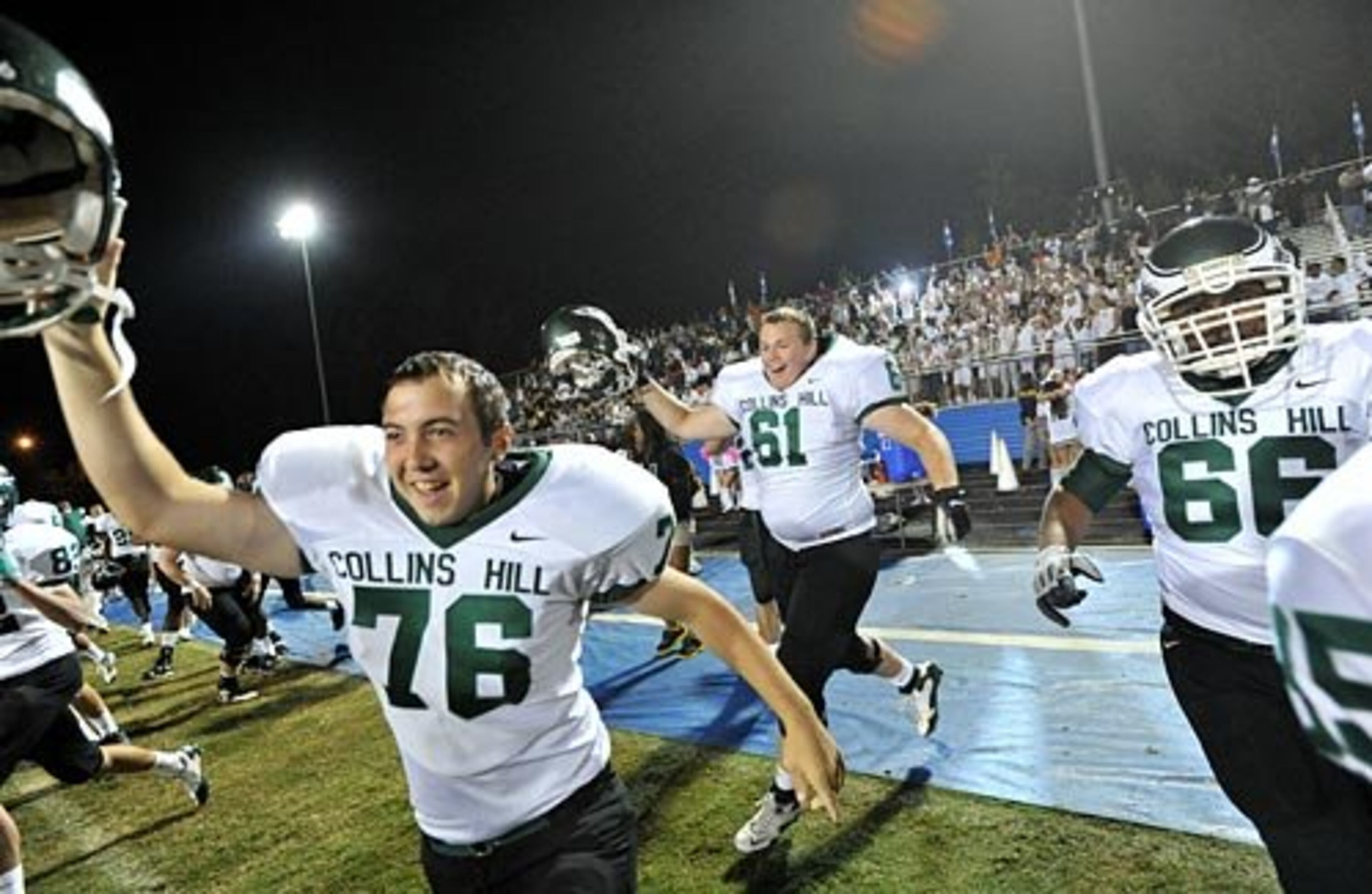 Collins Hill's Ken Houck (76) and Marshall Sutton (61) celebrate their 14 - 10 win over Peachtree Ridge.